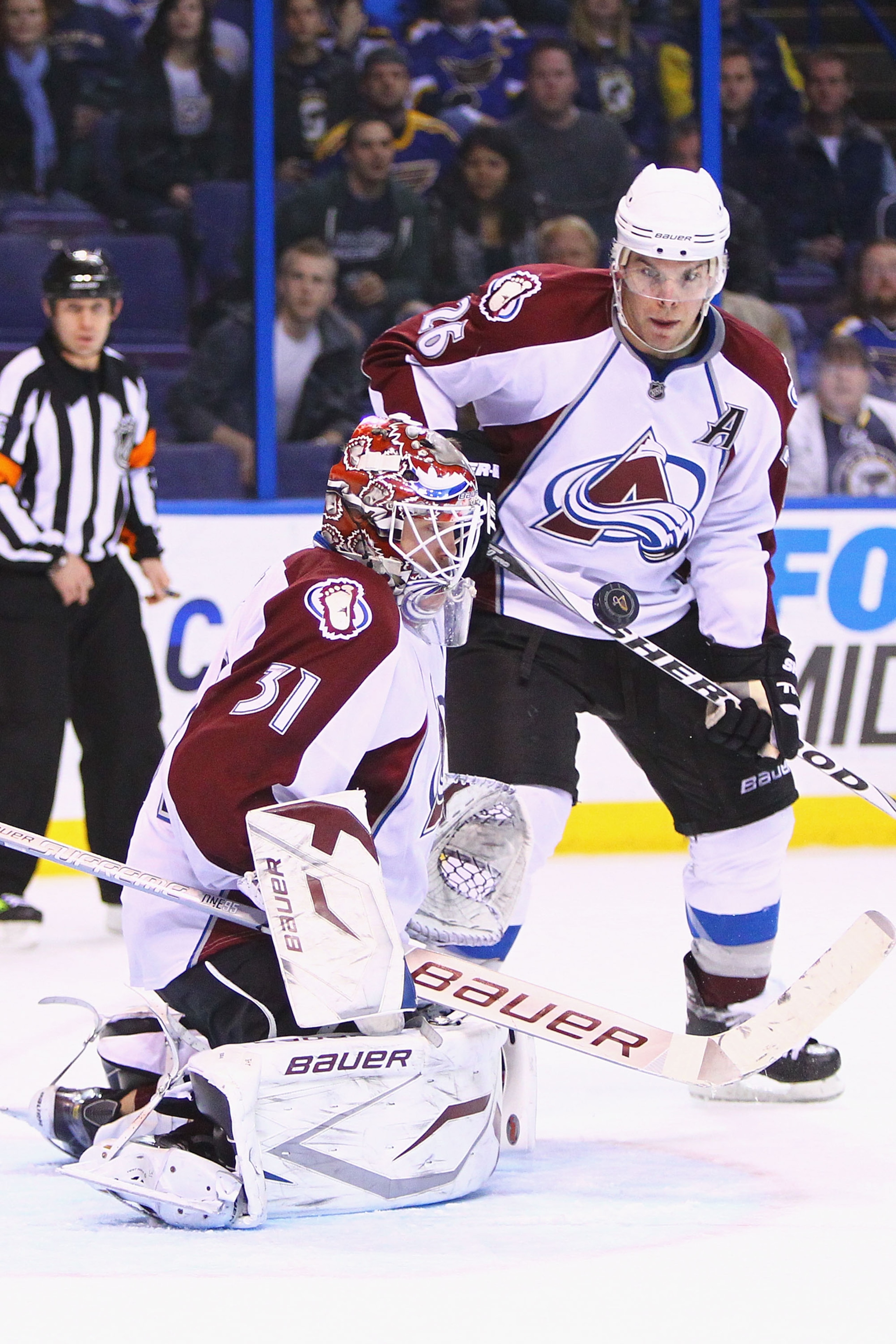ST. LOUIS, MO - FEBRUARY 22: Peter Budaj #31 of the Colorado Avalanche makes a save against the St. Louis Blues as Paul Stastny #26 also of the Colorado Avalanche looks on at the Scottrade Center on February 22, 2011 in St. Louis, Missouri.  (Photo by Dil