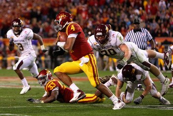 TEMPE, AZ - DECEMBER 31:  Quarterback Austen Arnaud #4 of the Iowa State Cyclones scrambles with the ball past Lee Campbell #30 of the Minnesota Golden Gophers during the Insight Bowl at Arizona Stadium on December 31, 2009 in Tempe, Arizona. The Cyclones