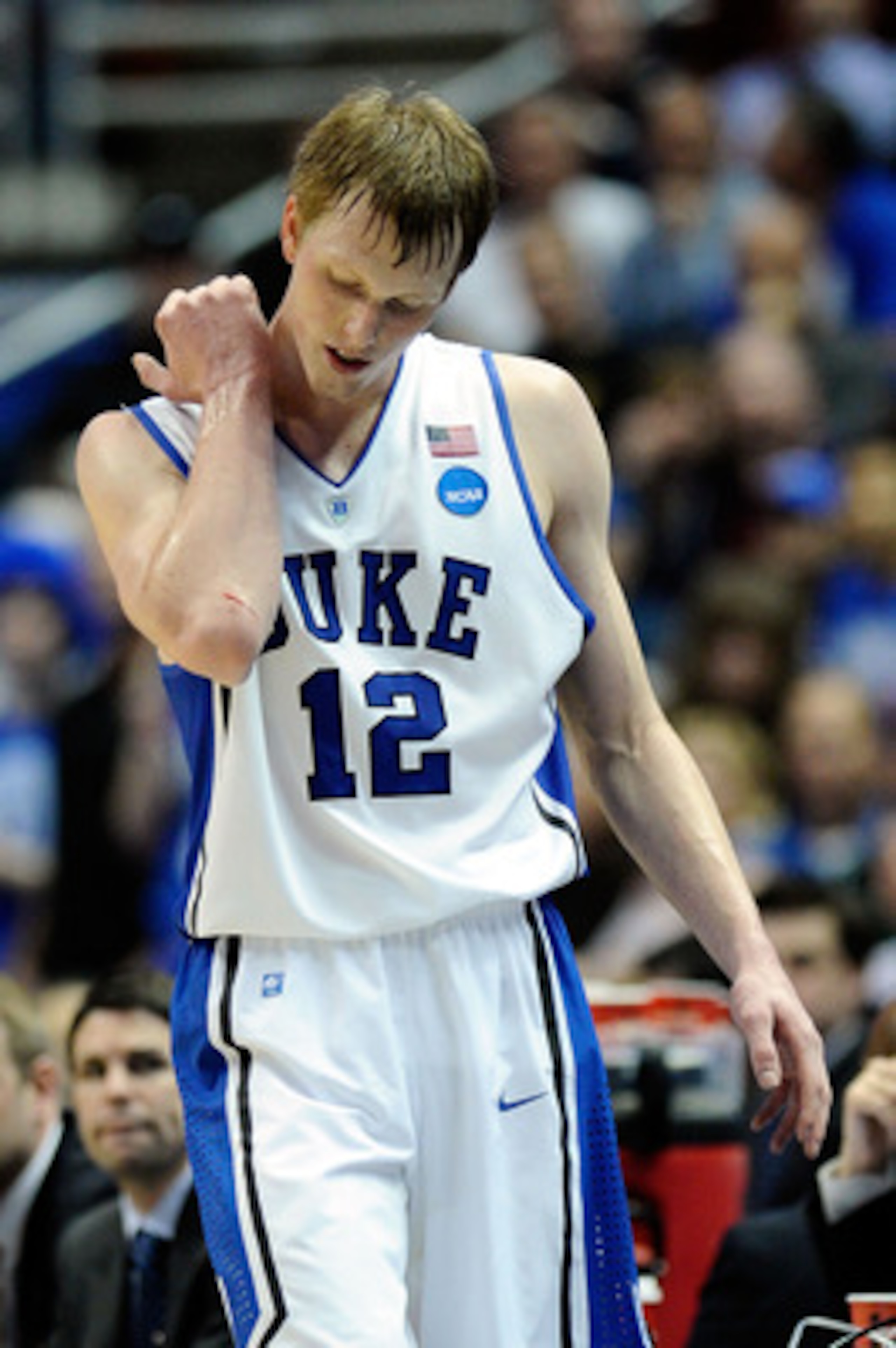 ANAHEIM, CA - MARCH 24:  Kyle Singler #12 of the Duke Blue Devils looks at a cut on his elbow while playing against the Arizona Wildcats during the west regional semifinal of the 2011 NCAA men's basketball tournament at the Honda Center on March 24, 2011