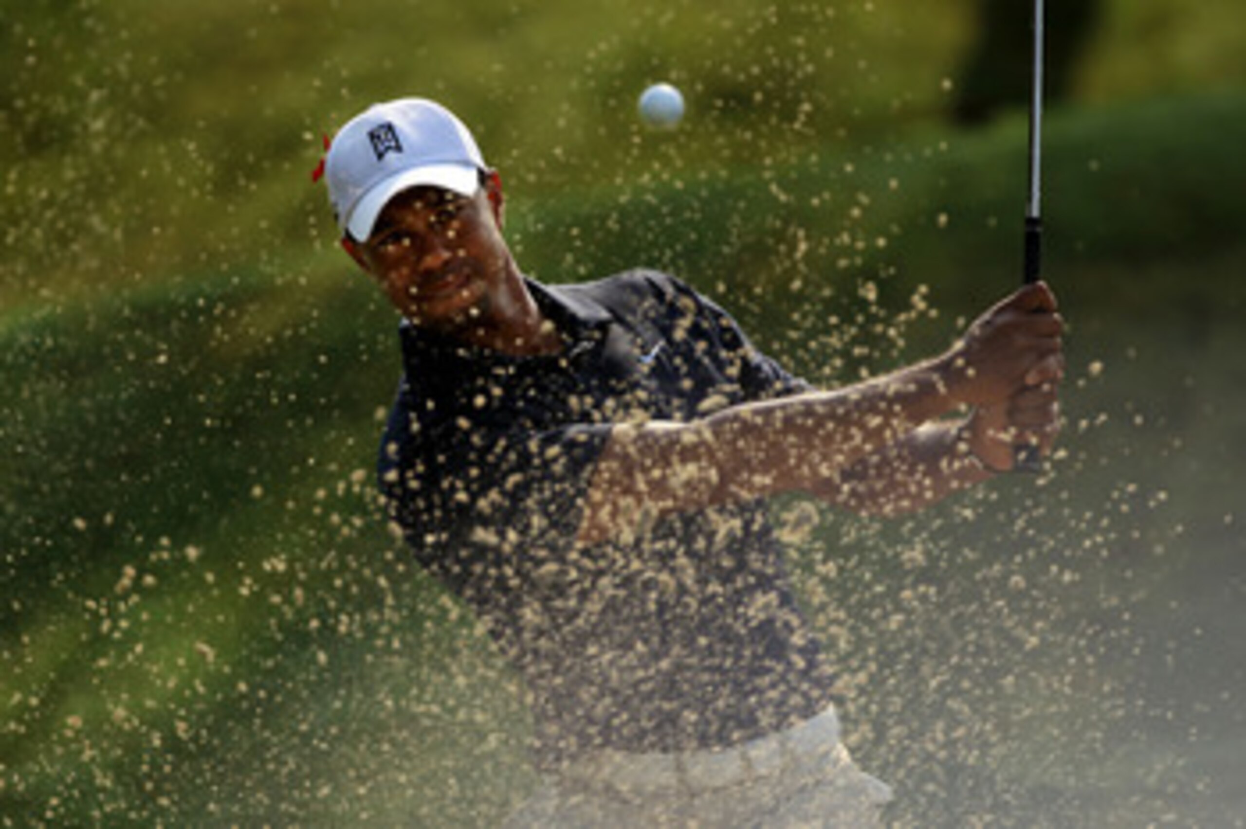 PONTE VEDRA BEACH, FL - MAY 12:  Tiger Woods hits from a bunker on the sixth hole during the first round of THE PLAYERS Championship held at THE PLAYERS Stadium course at TPC Sawgrass on May 12, 2011 in Ponte Vedra Beach, Florida. Woods withdrew after sho