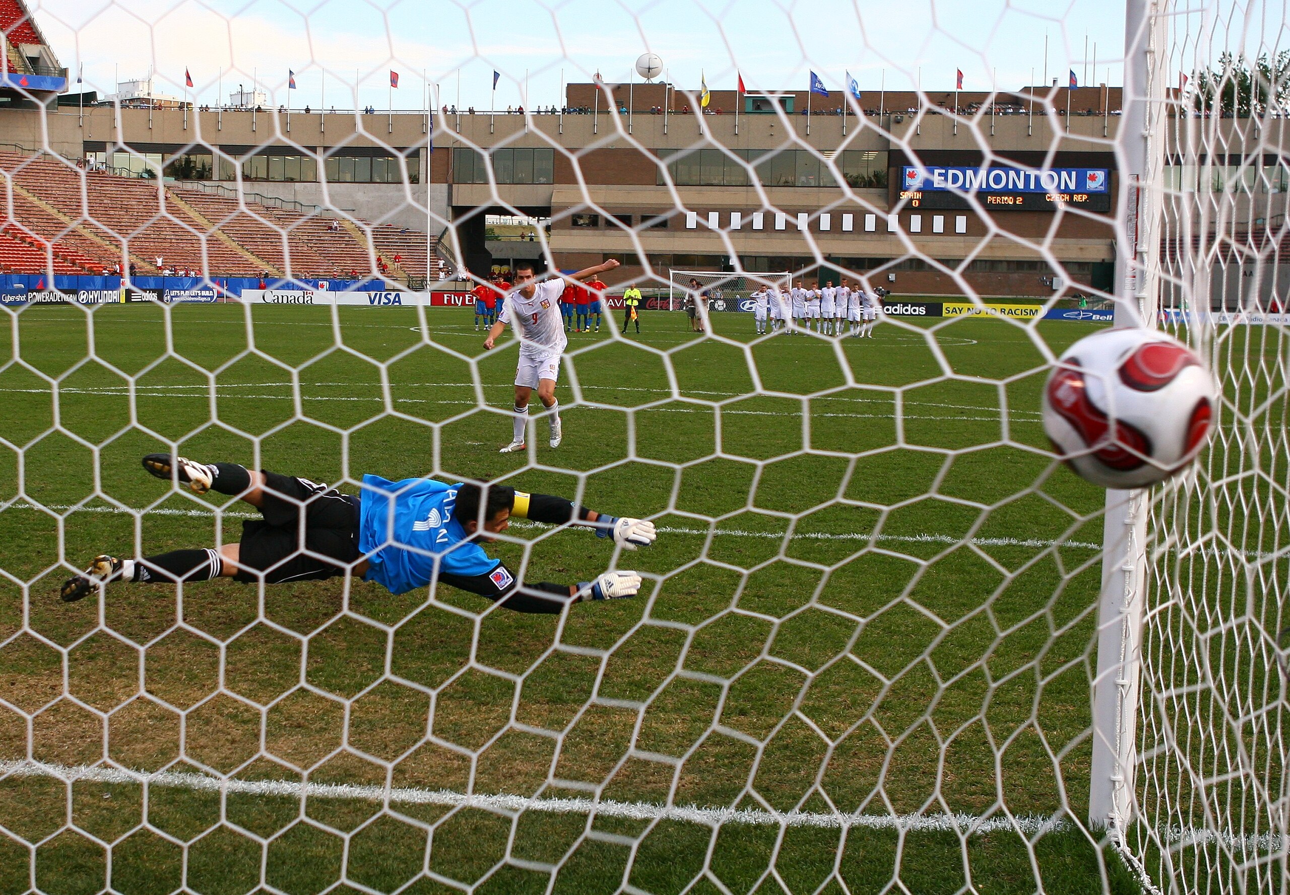 EDMONTON, CANADA - JULY 14:  Martin Fenin #9 of the Czech Republic scores on goalkeeper Adan #1 of Spain during the penalty shoot-out in their FIFA U-20 World Cup Canada 2007 quarter-final game at Commonwealth Stadium on July 14, 2007 in Edmonton, Alberta