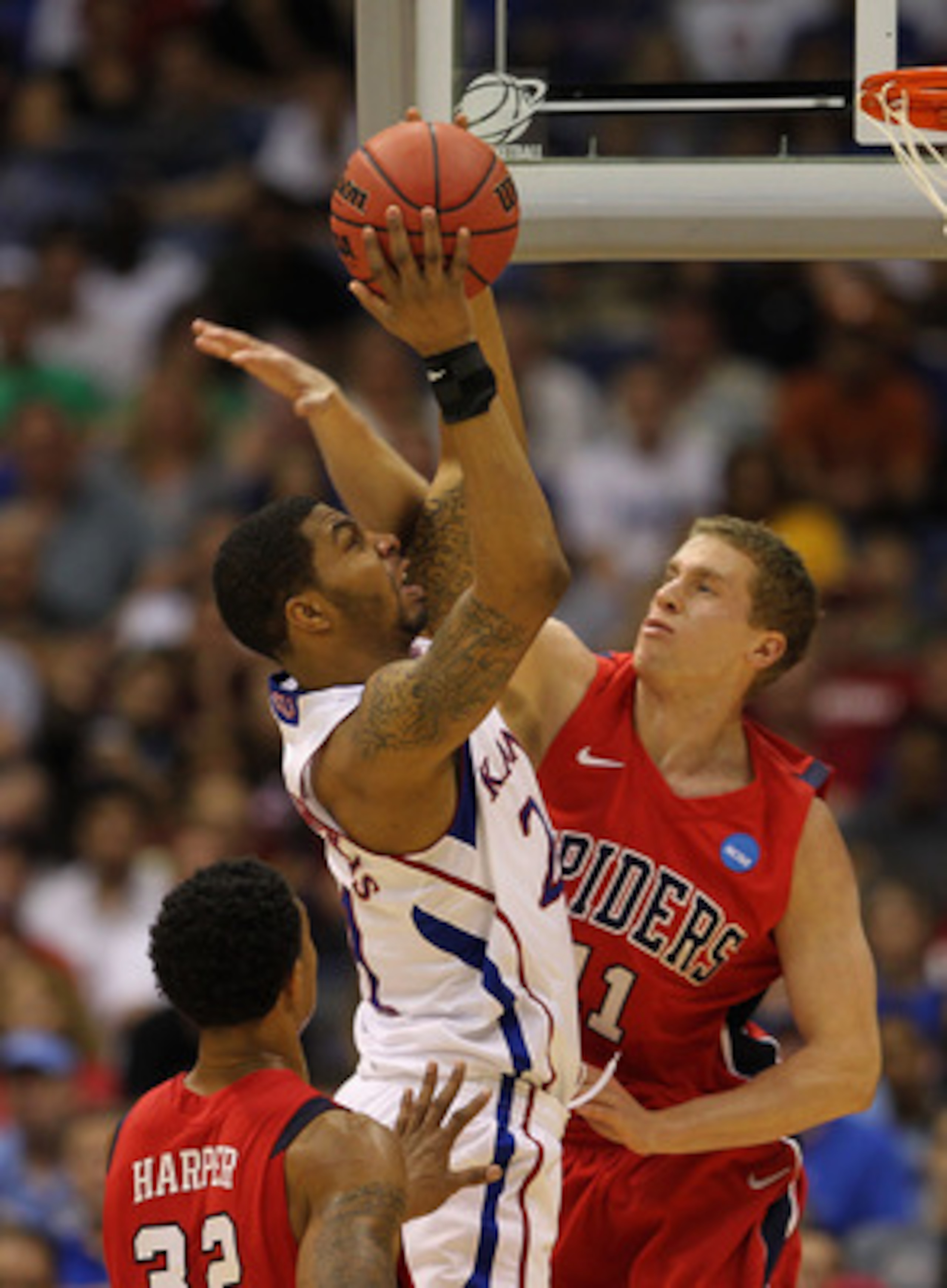 SAN ANTONIO, TX - MARCH 25:  Markieff Morris #21 of the Kansas Jayhawks goes to the basket against Josh Duinker #11 of the Richmond Spiders during the southwest regional of the 2011 NCAA men's basketball tournament at the Alamodome on March 25, 2011 in Sa