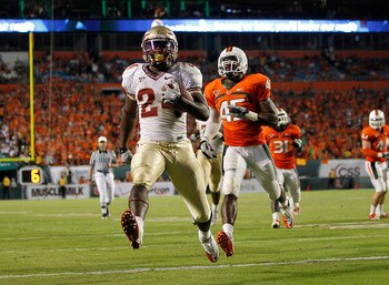 MIAMI, FL - OCTOBER 9: Lonnie Pryor #24 of the Florida State Seminoles scores a touchdown while being pursued by Ramon Buchanan #45 of the Miami Hurricanes on October 9, 2010 at Sun Life Stadium in Miami, Florida. The Seminoles defeated the Hurricanes 45-