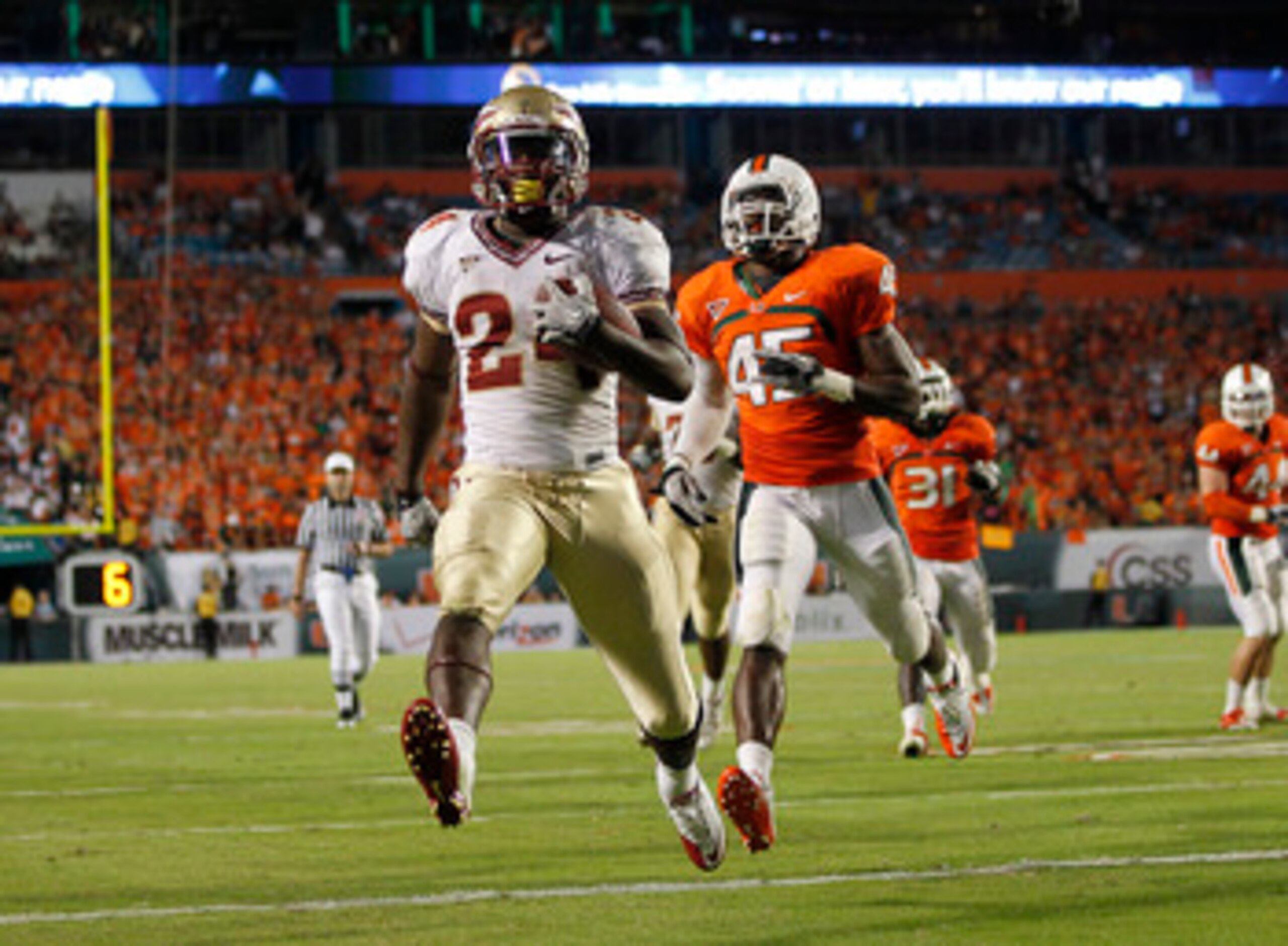 MIAMI, FL - OCTOBER 9: Lonnie Pryor #24 of the Florida State Seminoles scores a touchdown while being pursued by Ramon Buchanan #45 of the Miami Hurricanes on October 9, 2010 at Sun Life Stadium in Miami, Florida. The Seminoles defeated the Hurricanes 45-