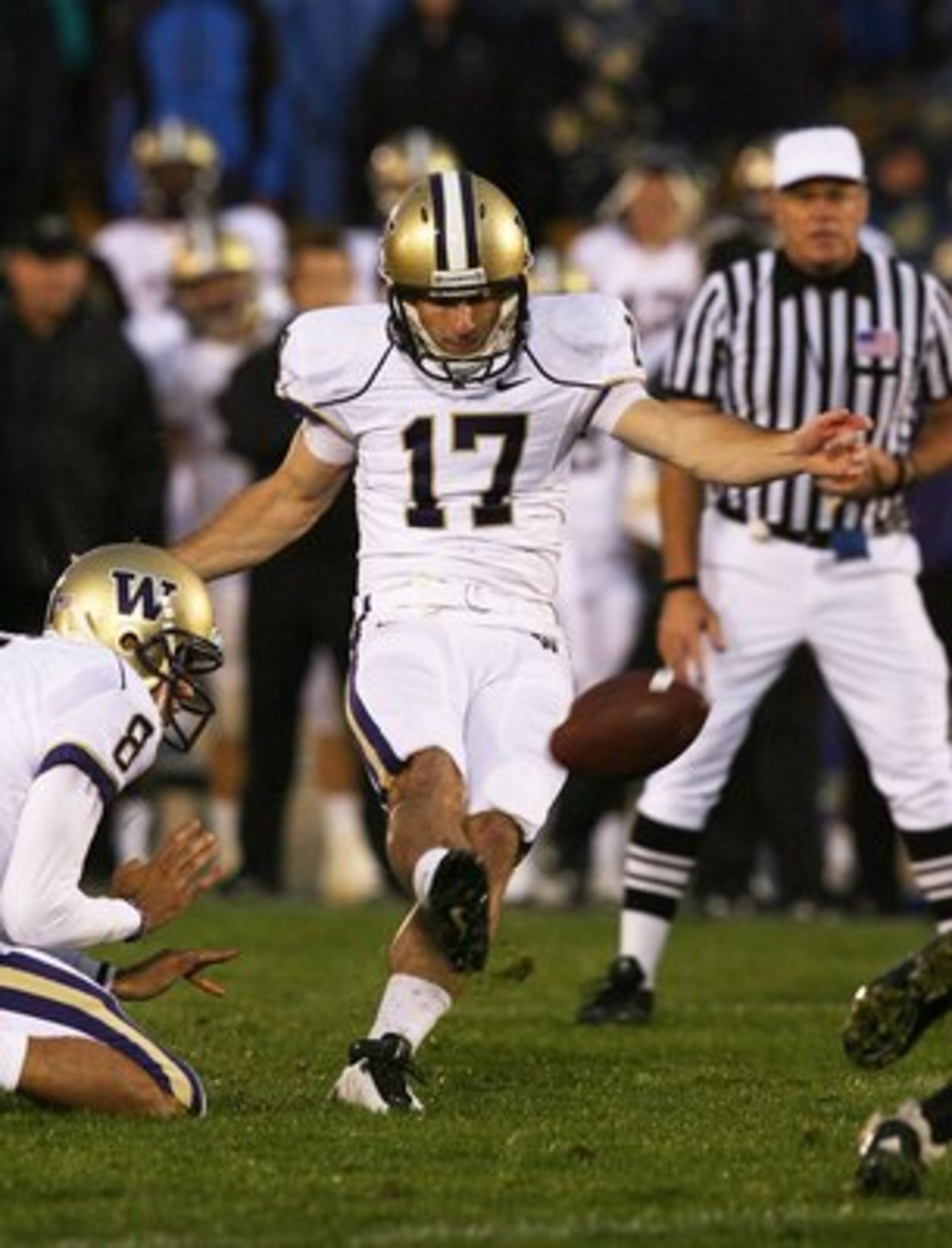 SOUTH BEND, IN - OCTOBER 03: Eric Folk #17 of the Washington Huskies kicks a field goal out of the hold of Ronnie Fouch #8 against the Notre Dame Fighting irish on October 3, 2009 at Notre Dame Stadium in South Bend, Indiana. Notre Dame defeated Washingto
