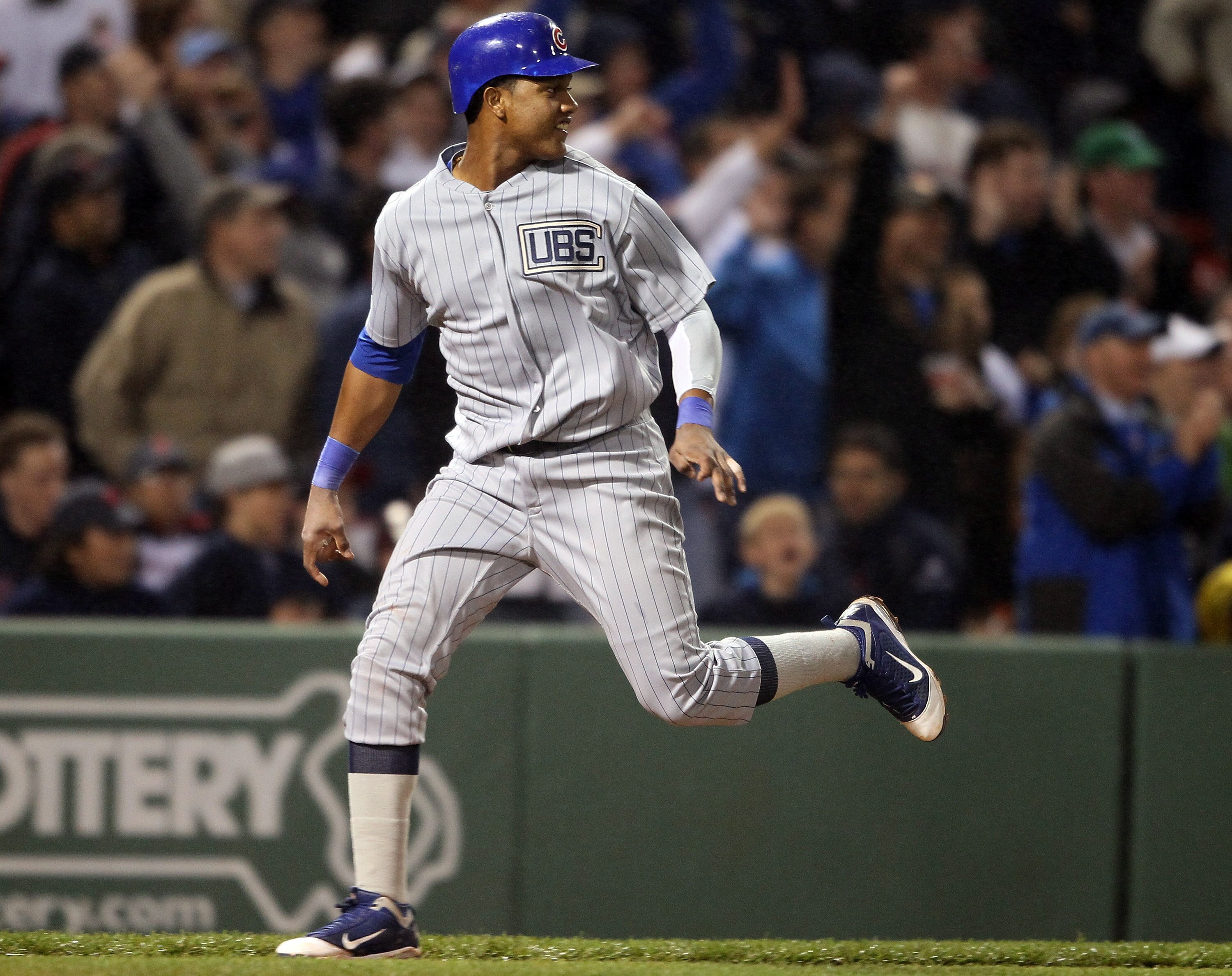 BOSTON, MA - MAY 21:  Starlin Castro #13 of the Chicago Cubs scores on a hits a by teammate Reed Johnson in the eighth inning against the Boston Red Sox on May 21, 2011 at Fenway Park in Boston, Massachusetts. Tonight the Chicago Cubs and the Boston Red S