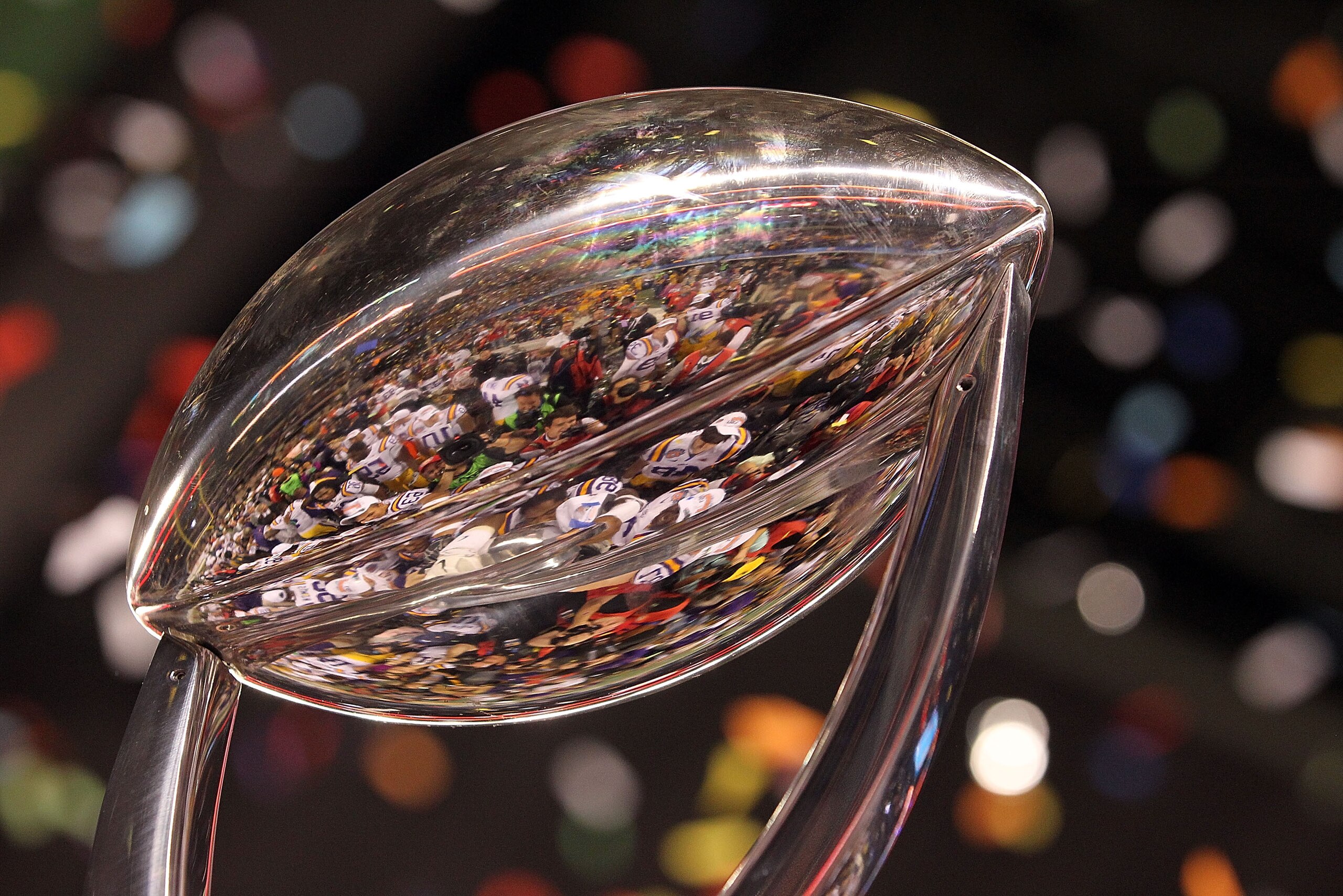 ARLINGTON, TX - JANUARY 07: The LSU Tigers are reflected in the Cotton Bowl Championship trophy while celebrating a 41-24 win against the Texas A&M Aggies during the AT&T Cotton Bowl at Cowboys Stadium on January 7, 2011 in Arlington, Texas. (Photo by R ARLINGTON, TX - JANUARY 07: The LSU Tigers are reflected in the Cotton Bowl Championship trophy while celebrating a 41-24 win against the Texas A&M Aggies during the AT&T Cotton Bowl at Cowboys Stadium on January 7, 2011 in Arlington, Texas. (Photo by R