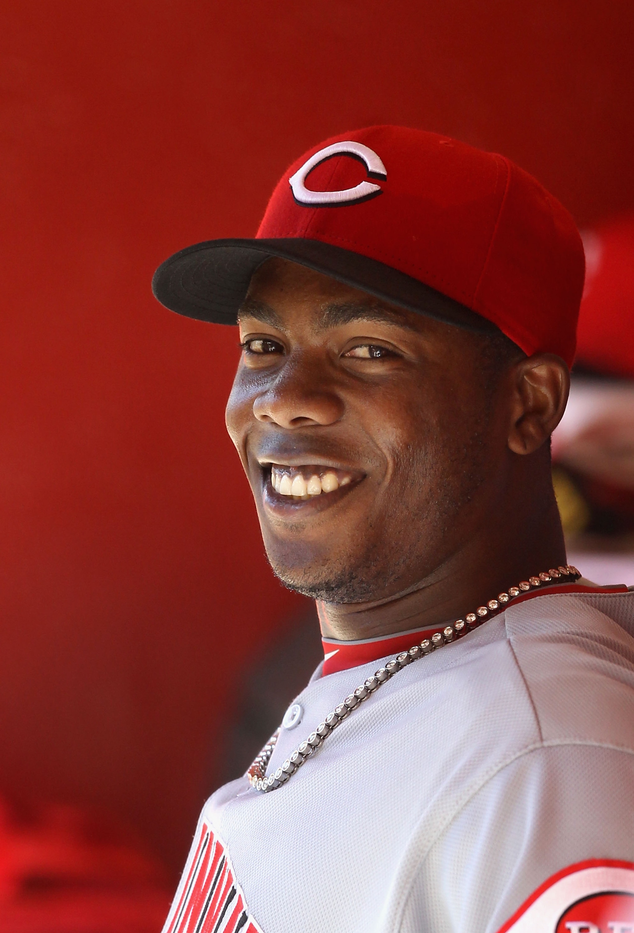 PHOENIX, AZ - APRIL 10:  Relief pitcher Aroldis Chapman #54 of the Cincinnati Reds smiles in the dugout during the Major League Baseball game against the Arizona Diamondbacks at Chase Field on April 10, 2011 in Phoenix, Arizona. The Diamondbacks defeated