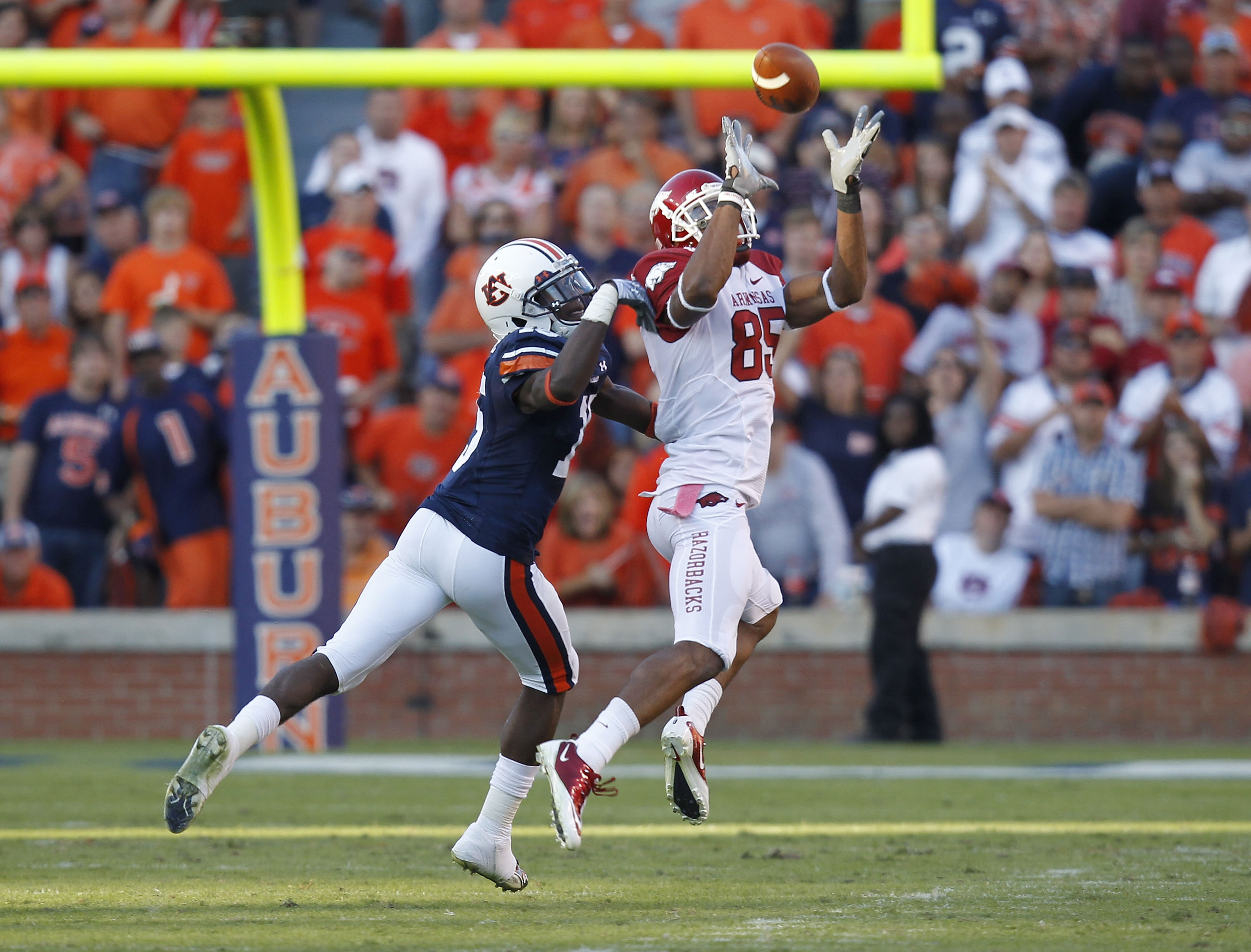 AUBURN - OCTOBER 16: Wide receiver Greg Childs #85 of the Arkansas Razorbacks catches a pass behind defensive back Neiko Thorpe #15 of the Auburn Tigers during the game at Jordan-Hare Stadium on October 16, 2010 in Auburn, Alabama. The Tigers beat the R AUBURN - OCTOBER 16: Wide receiver Greg Childs #85 of the Arkansas Razorbacks catches a pass behind defensive back Neiko Thorpe #15 of the Auburn Tigers during the game at Jordan-Hare Stadium on October 16, 2010 in Auburn, Alabama. The Tigers beat the R