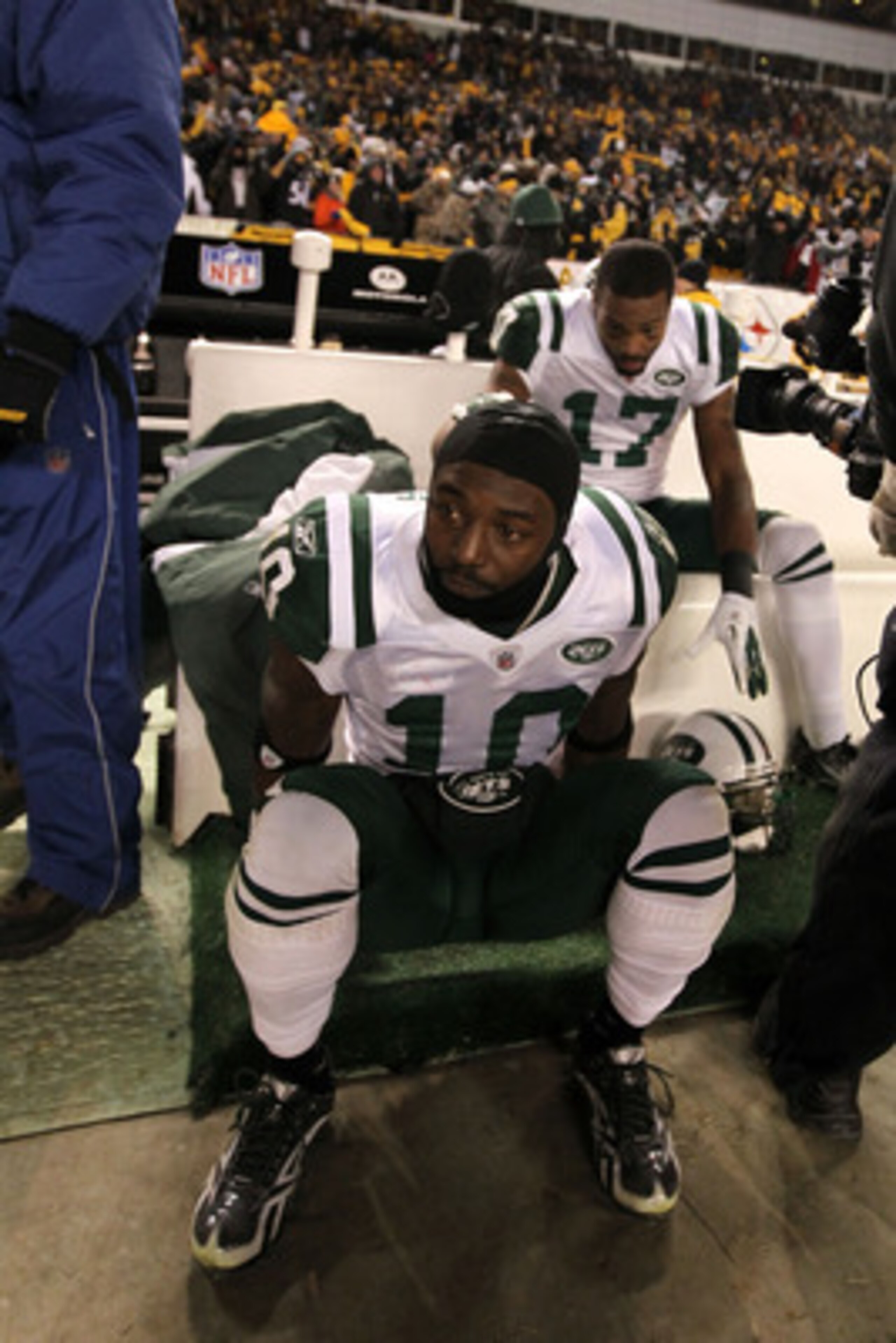 PITTSBURGH, PA - JANUARY 23:  Santonio Holmes #10 and Braylon Edwards #17 of the New York Jets sit dejected after being defeated 24 to 19 by the Pittsburgh Steelers in the 2011 AFC Championship game at Heinz Field on January 23, 2011 in Pittsburgh, Pennsy