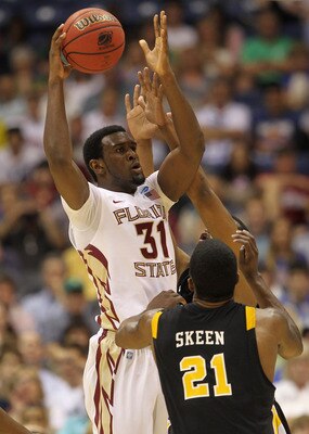 SAN ANTONIO, TX - MARCH 25:  Chris Singleton #31 of the Florida State Seminoles looks to pass the ball against Jamie Skeen #21 of the Virginia Commonwealth Rams during the southwest regional of the 2011 NCAA men's basketball tournament at the Alamodome on