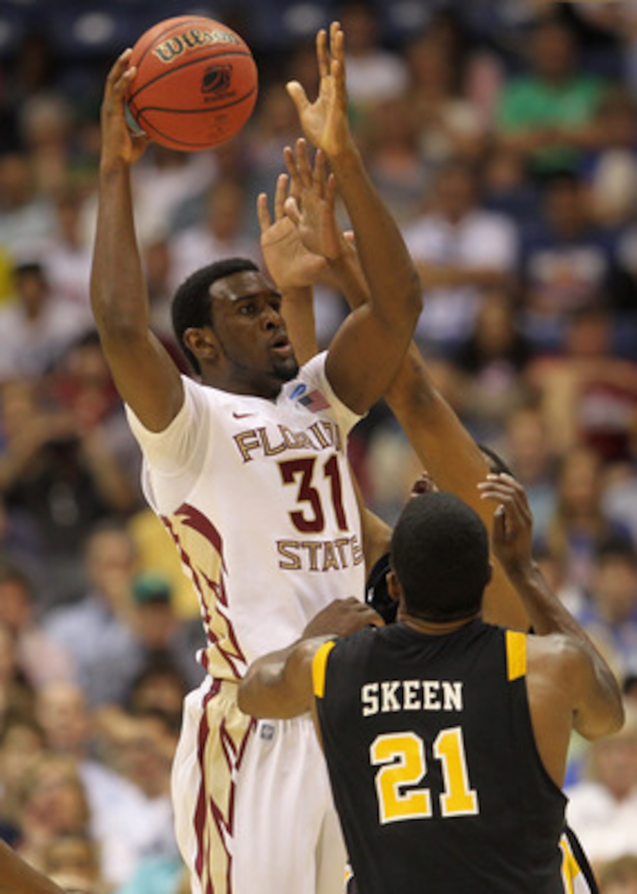 SAN ANTONIO, TX - MARCH 25:  Chris Singleton #31 of the Florida State Seminoles looks to pass the ball against Jamie Skeen #21 of the Virginia Commonwealth Rams during the southwest regional of the 2011 NCAA men's basketball tournament at the Alamodome on