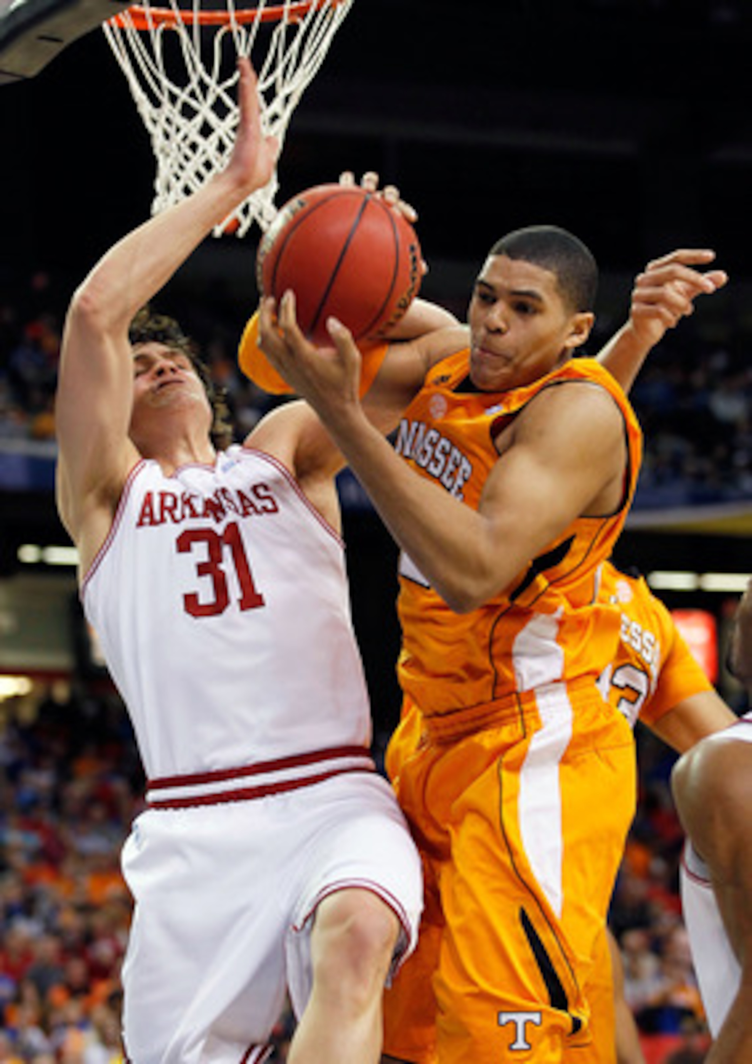 ATLANTA, GA - MARCH 10:  Michael Sanchez #31 of the Arkansas Razorbacks and Tobias Harris #12 of the Tennessee Volunteers fight for a rebound during the first round of the SEC Men's Basketball Tournament at the Georgia Dome on March 10, 2011 in Atlanta, G
