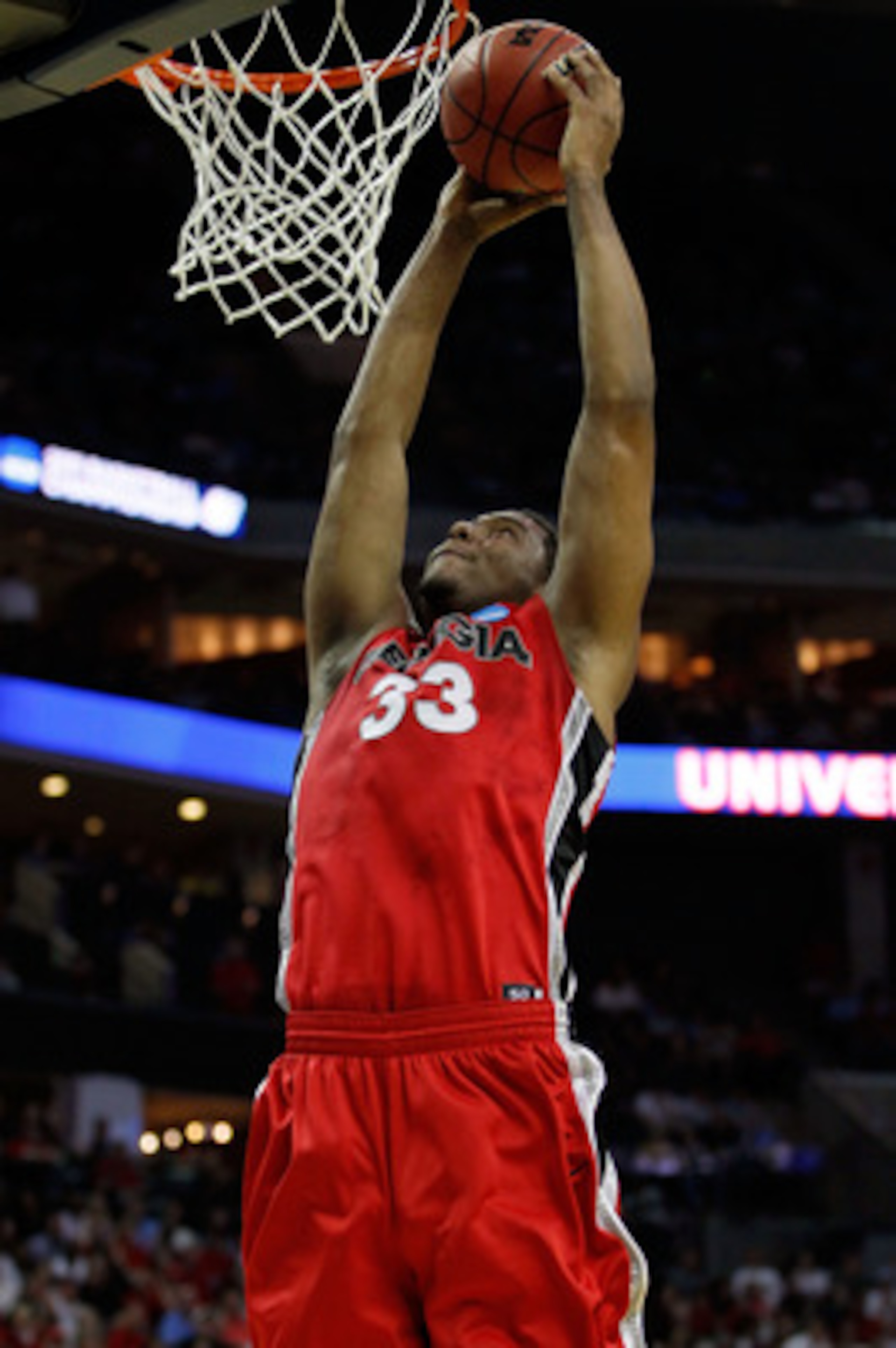 CHARLOTTE, NC - MARCH 18:  Trey Thompkins #33 of the Georgia Bulldogs dunks the ball in the first half while taking on the Washington Huskies during the second round of the 2011 NCAA men's basketball tournament at Time Warner Cable Arena on March 18, 2011
