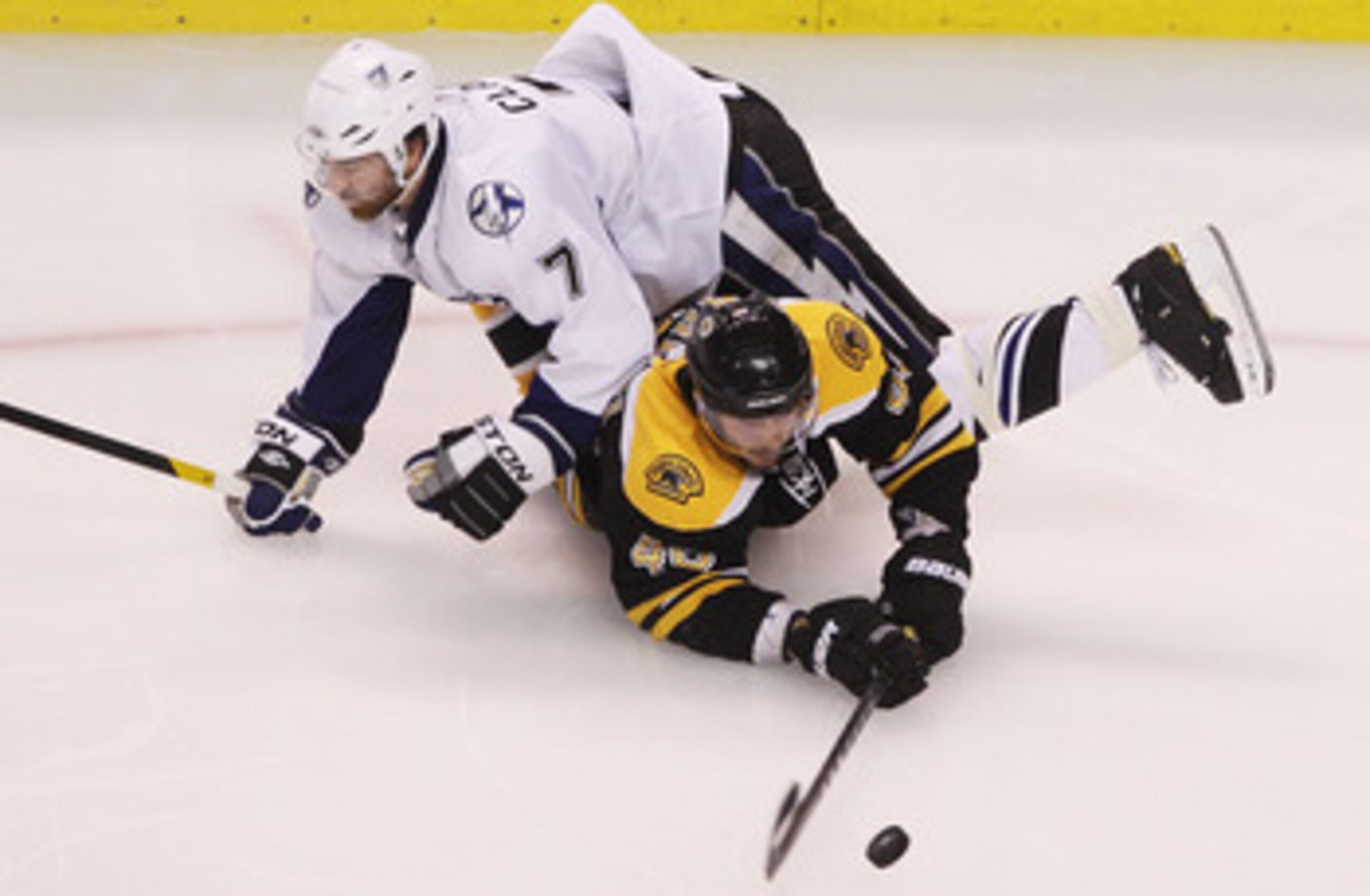 BOSTON, MA - MAY 23: Brett Clark #7 of the Tampa Bay Lightning falls on David Krejci #46 of the Boston Bruins in Game Five of the Eastern Conference Finals during the 2011 NHL Stanley Cup Playoffs at TD Garden on May 23, 2011 in Boston, Massachusetts. ( BOSTON, MA - MAY 23: Brett Clark #7 of the Tampa Bay Lightning falls on David Krejci #46 of the Boston Bruins in Game Five of the Eastern Conference Finals during the 2011 NHL Stanley Cup Playoffs at TD Garden on May 23, 2011 in Boston, Massachusetts. (