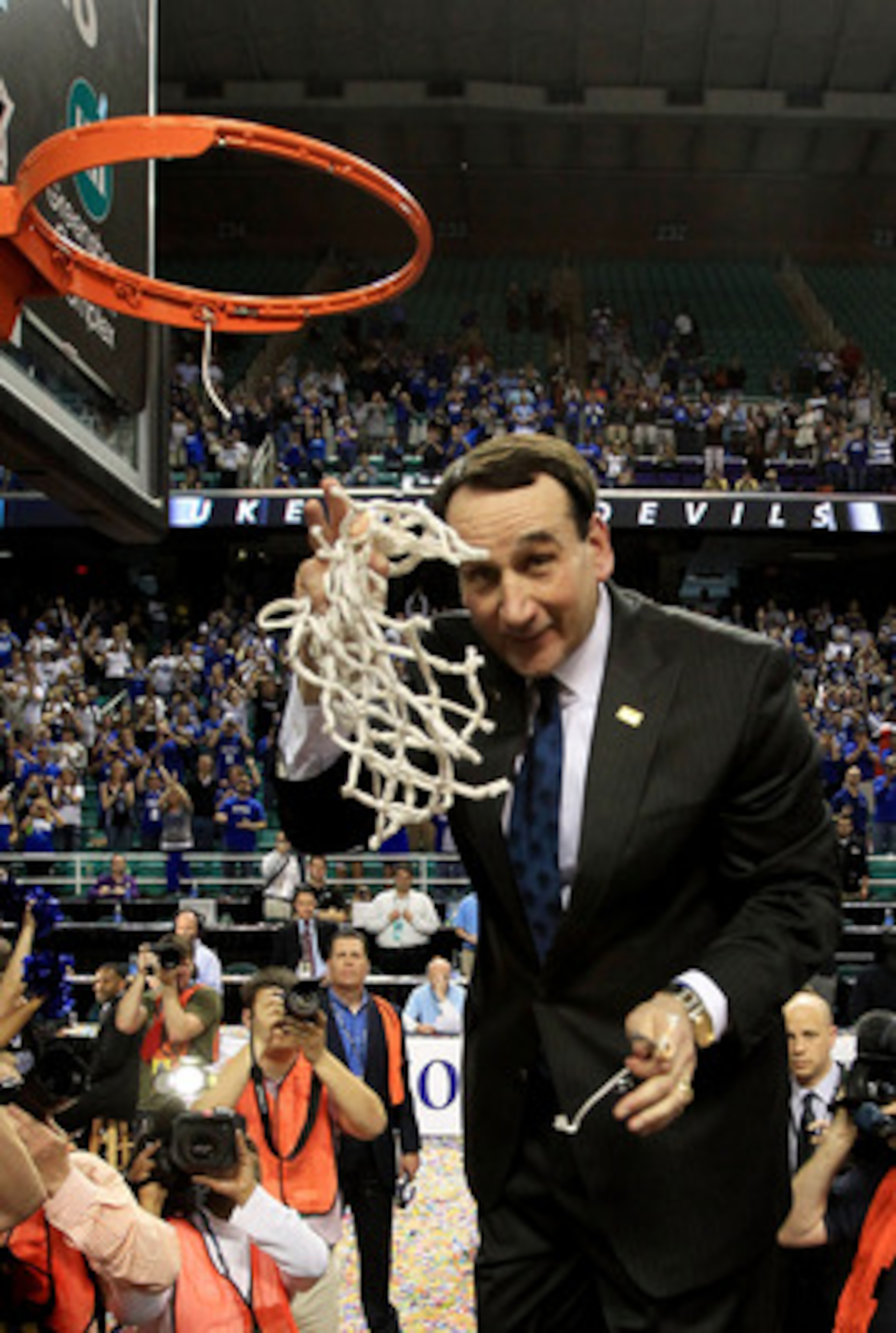 GREENSBORO, NC - MARCH 13: Head coach Mike Krzyzewski of the Duke Blue Devils cuts down the net after defeating the North Carolina Tar Heels 75-58 in the championship game of the 2011 ACC men's basketball tournament at the Greensboro Coliseum on March 13 GREENSBORO, NC - MARCH 13: Head coach Mike Krzyzewski of the Duke Blue Devils cuts down the net after defeating the North Carolina Tar Heels 75-58 in the championship game of the 2011 ACC men's basketball tournament at the Greensboro Coliseum on March 13