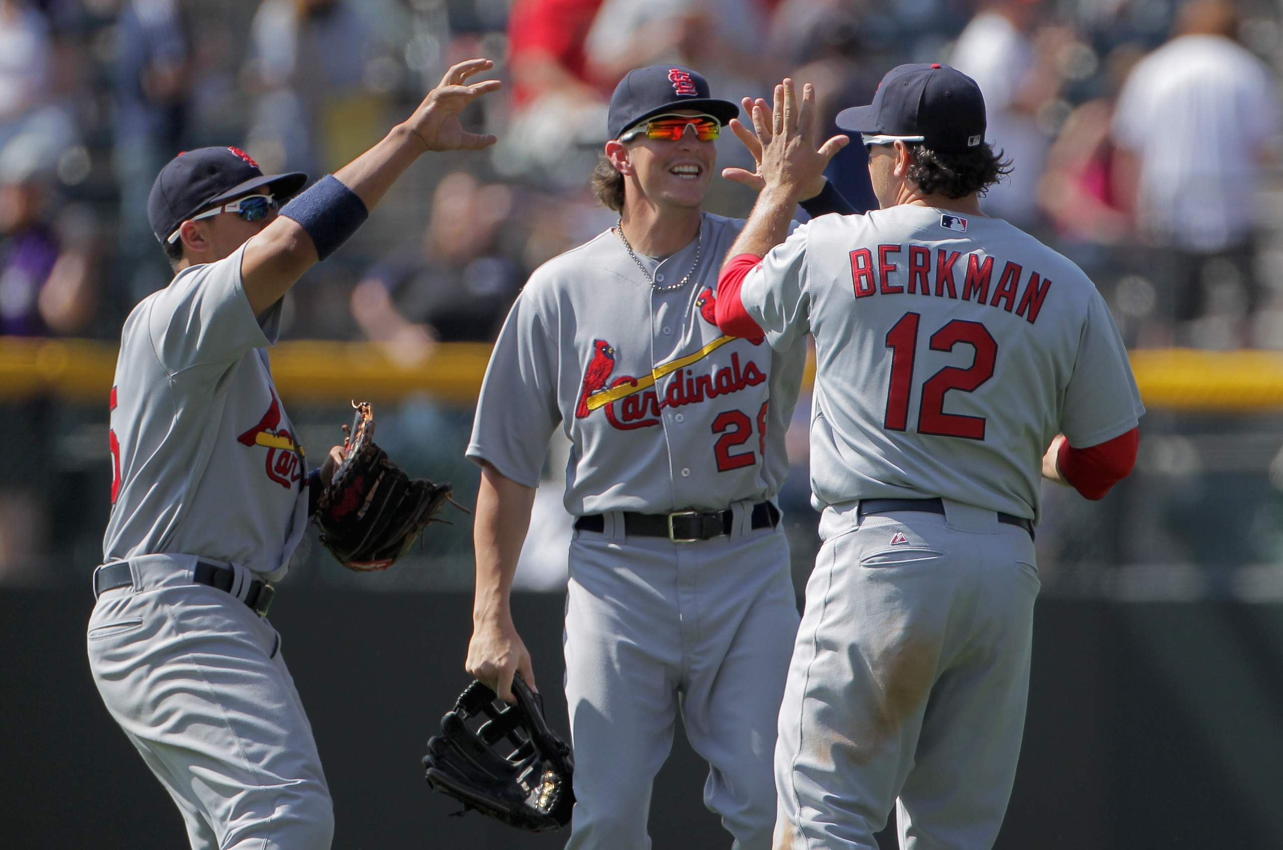 DENVER, CO - MAY 29:  Outfielders Jon Jay #15, Colby Rasmus #28 and Lance Berkman #12 of the St. Louis Cardinals celebrate their 4-3 victory over the Colorado Rockies at Coors Field on May 29, 2011 in Denver, Colorado.  (Photo by Doug Pensinger/Getty Imag