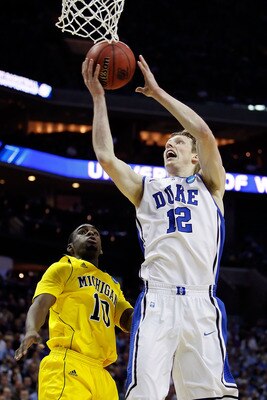 CHARLOTTE, NC - MARCH 20:  Kyle Singler #12 of the Duke Blue Devils goes up for a shot against Tim Hardaway Jr. #10 of the Michigan Wolverines in the first half during the third round of the 2011 NCAA men's basketball tournament at Time Warner Cable Arena
