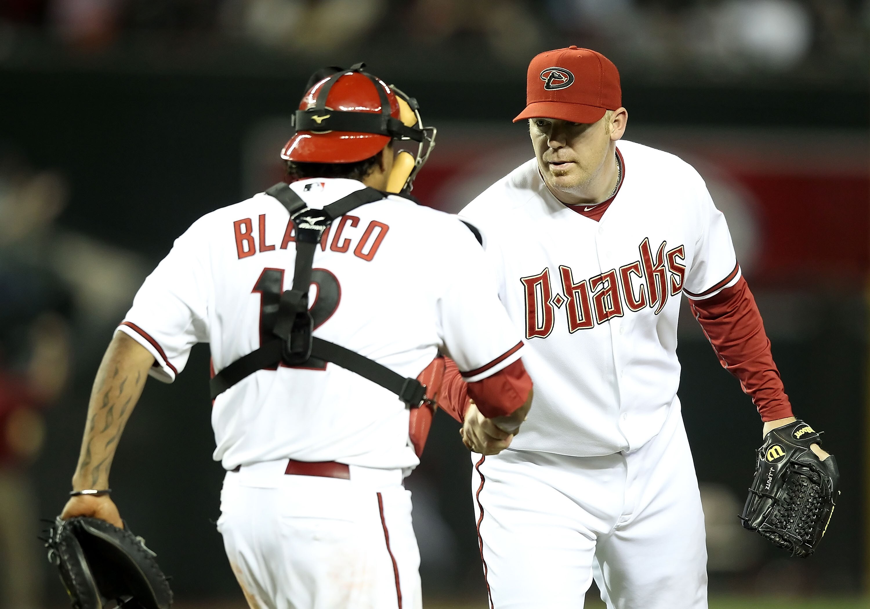 PHOENIX, AZ - MAY 03:  Relief pitcher J.J. Putz #40 of the Arizona Diamondbacks celebrates with catcher Henry Blanco #12 after defeating the Colorado Rockies in the Major League Baseball game at Chase Field on May 3, 2011 in Phoenix, Arizona. The Diamondb