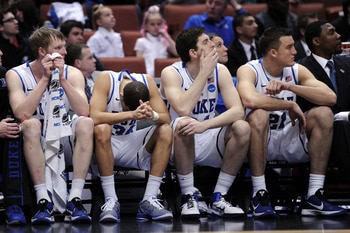 ANAHEIM, CA - MARCH 24:  Kyle Singler #12, Seth Curry #30, Ryan Kelly #34 and Miles Plumlee #21 of the Duke Blue Devils look on from the bench against the Arizona Wildcats during the west regional semifinal of the 2011 NCAA men's basketball tournament at 