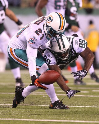 EAST RUTHERFORD, NJ - DECEMBER 12: Jerricho Cotchery #89 of the New York Jets has a pass broken up by Vontae Davis #21 of the Miami Dolphins at New Meadowlands Stadium on December 12, 2010 in East Rutherford, New Jersey.  (Photo by Nick Laham/Getty Images