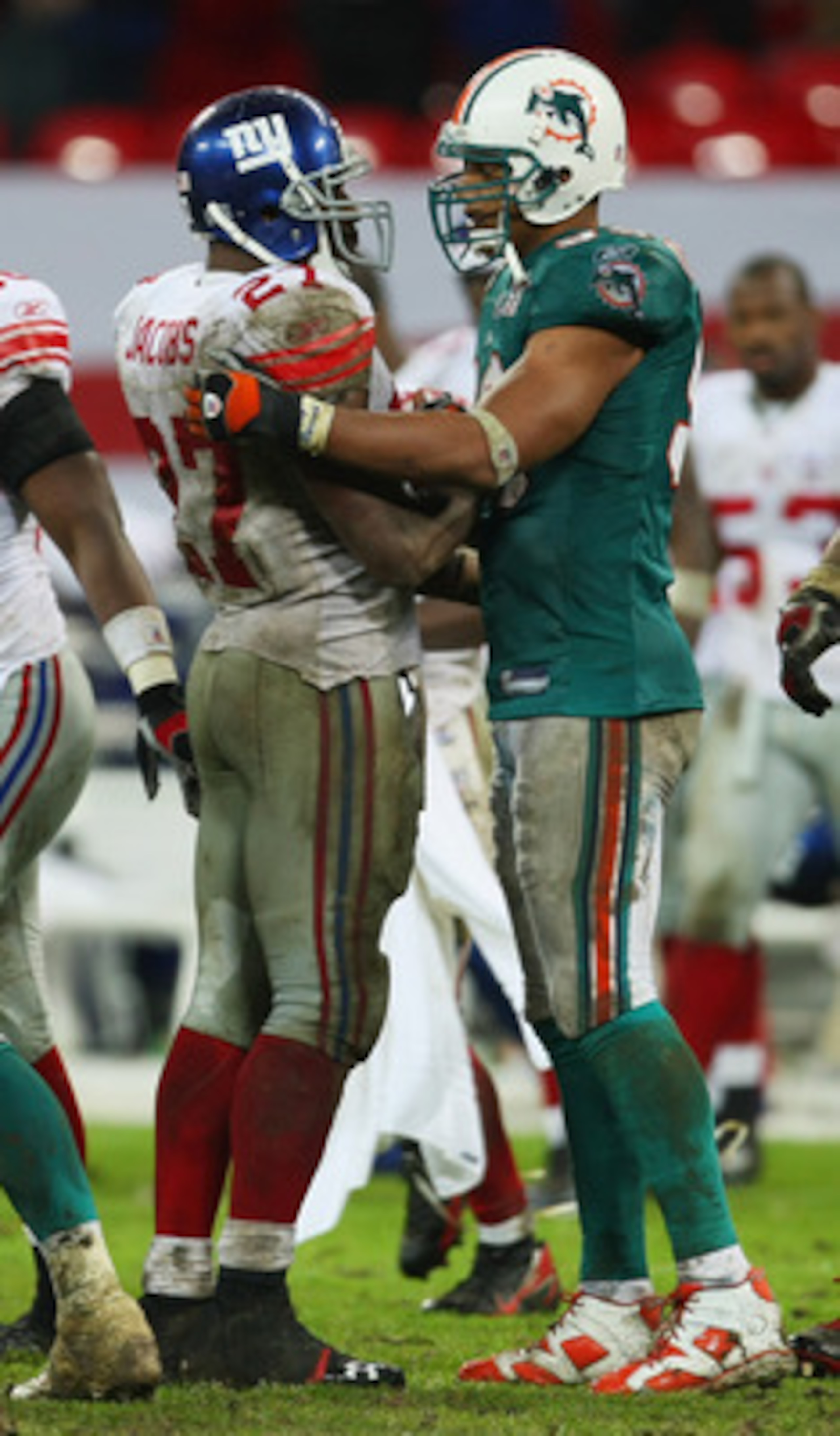 LONDON - OCTOBER 28:  Brandon Jacobs #27 of the Giants is hugged by Jason Taylor #99 of the Dolphins following the final play of the game during the NFL Bridgestone International Series match between New York Giants and  Miami Dolphins at Wembley Stadium