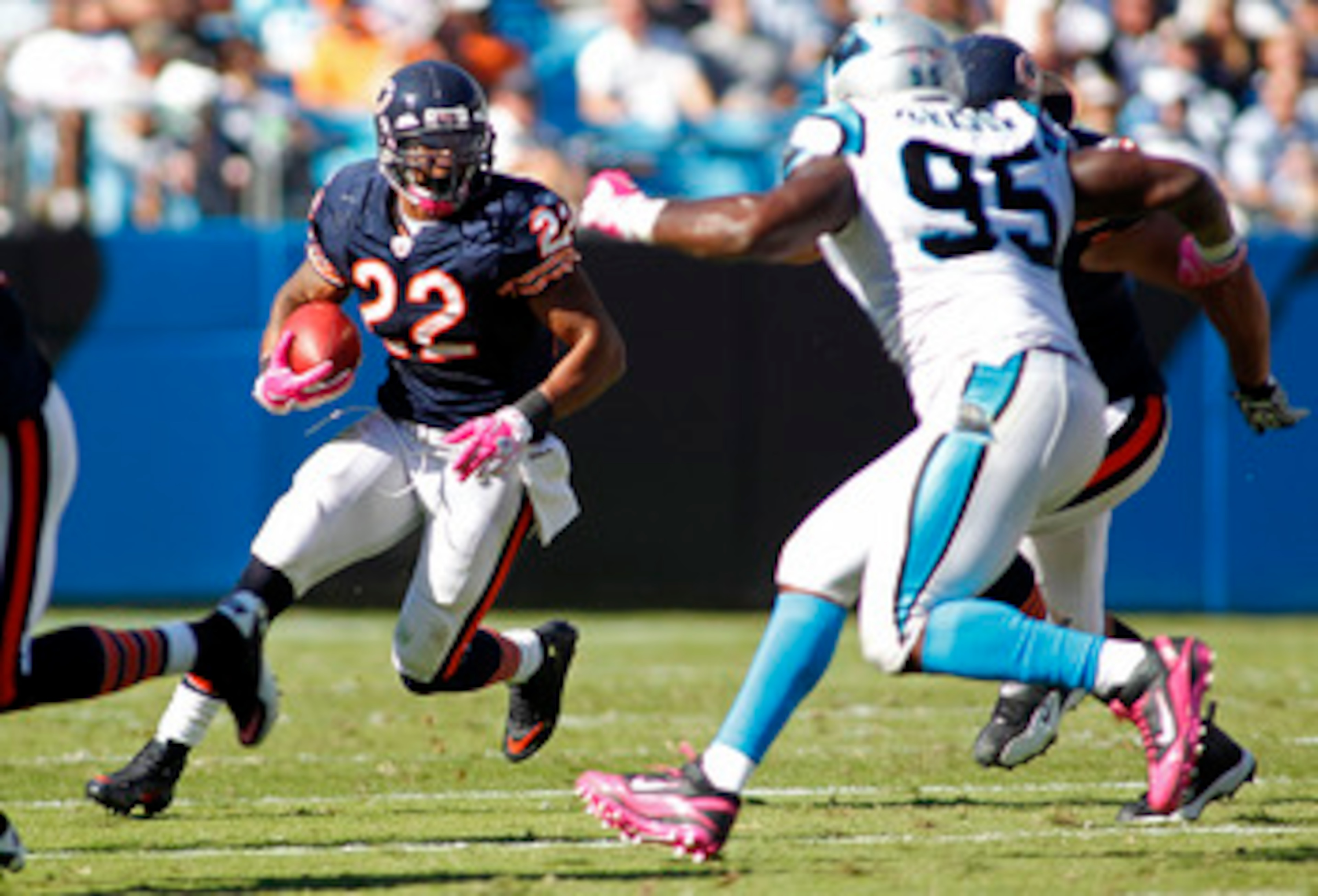 CHARLOTTE, NC - OCTOBER 10: Running back Matt Forte #22 of the Chicago Bears runs with the ball as defensive end Charles Johnson #95 of the Carolina Panthers defends at Bank of America Stadium on October 10, 2010 in Charlotte, North Carolina. (Photo by Ge