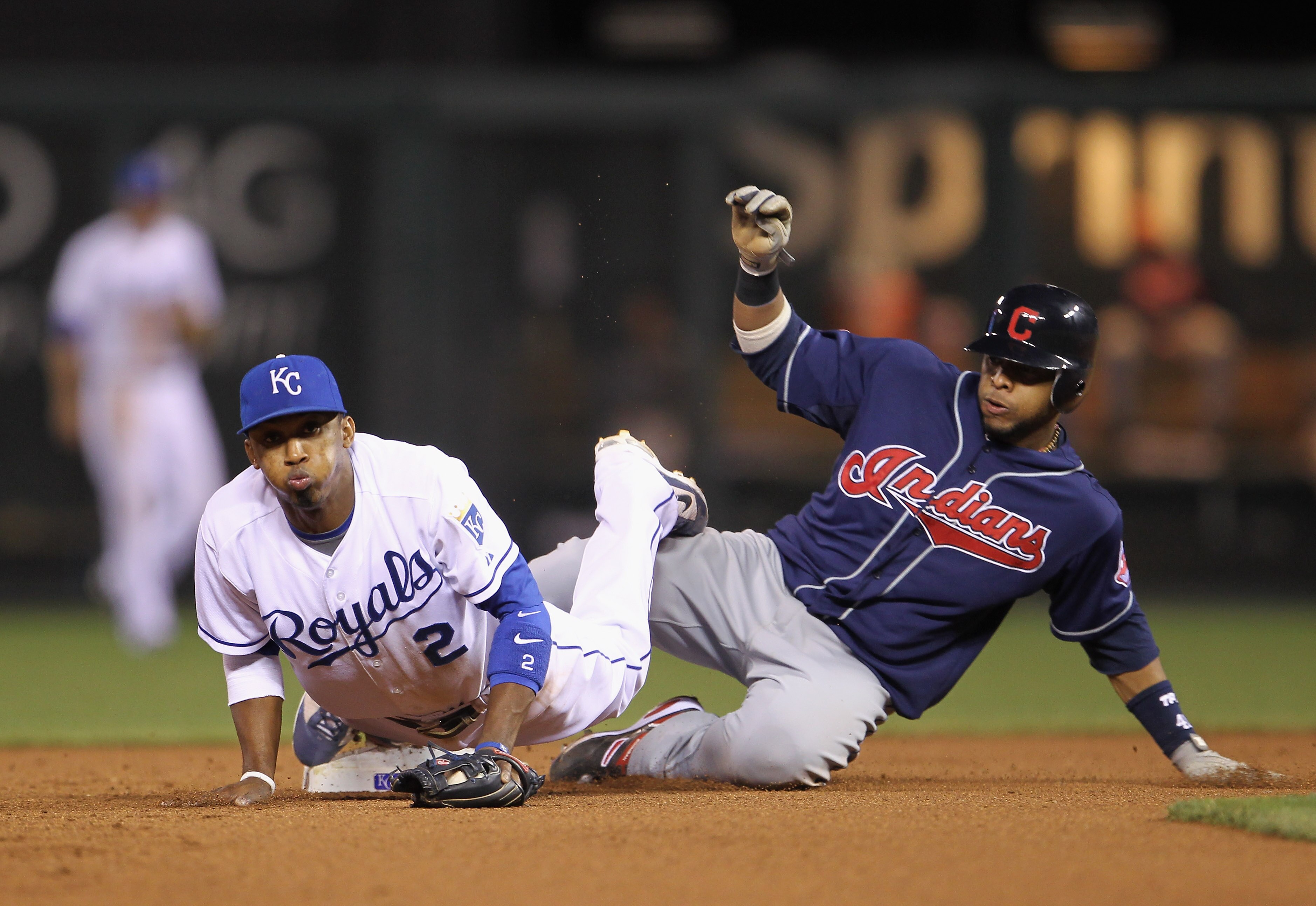 KANSAS CITY, MO - MAY 17:  Carlos Santana #41 of the Cleveland Indians is out at second as shortstop Alcides Escobar #2 of the Kansas City Royals dives onto the bag during the 7th inning of the game on May 17, 2011 at Kauffman Stadium in Kansas City, Miss