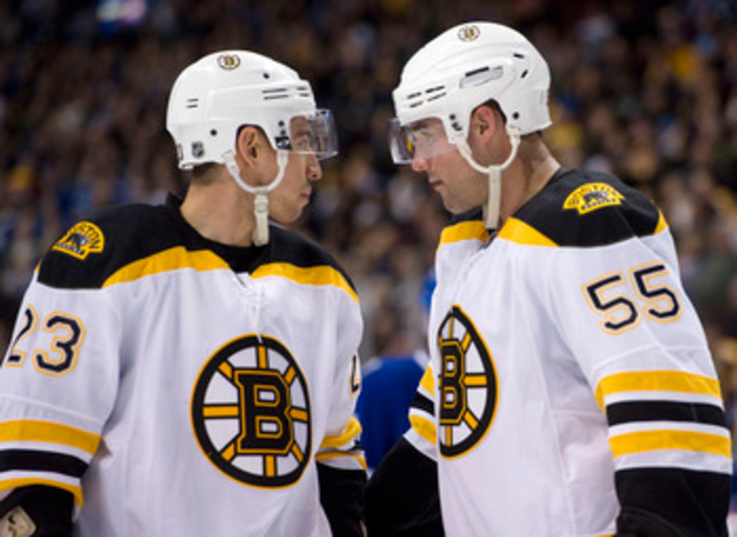 VANCOUVER, CANADA - FEBRUARY 26:  Chris Kelly #23 and Johnny Boychuck #55 of the Boston Bruins stand on the ice during the second period in NHL action on February 26, 2011 at Rogers Arena in Vancouver, British Columbia, Canada.  (Photo by Rich Lam/Getty I