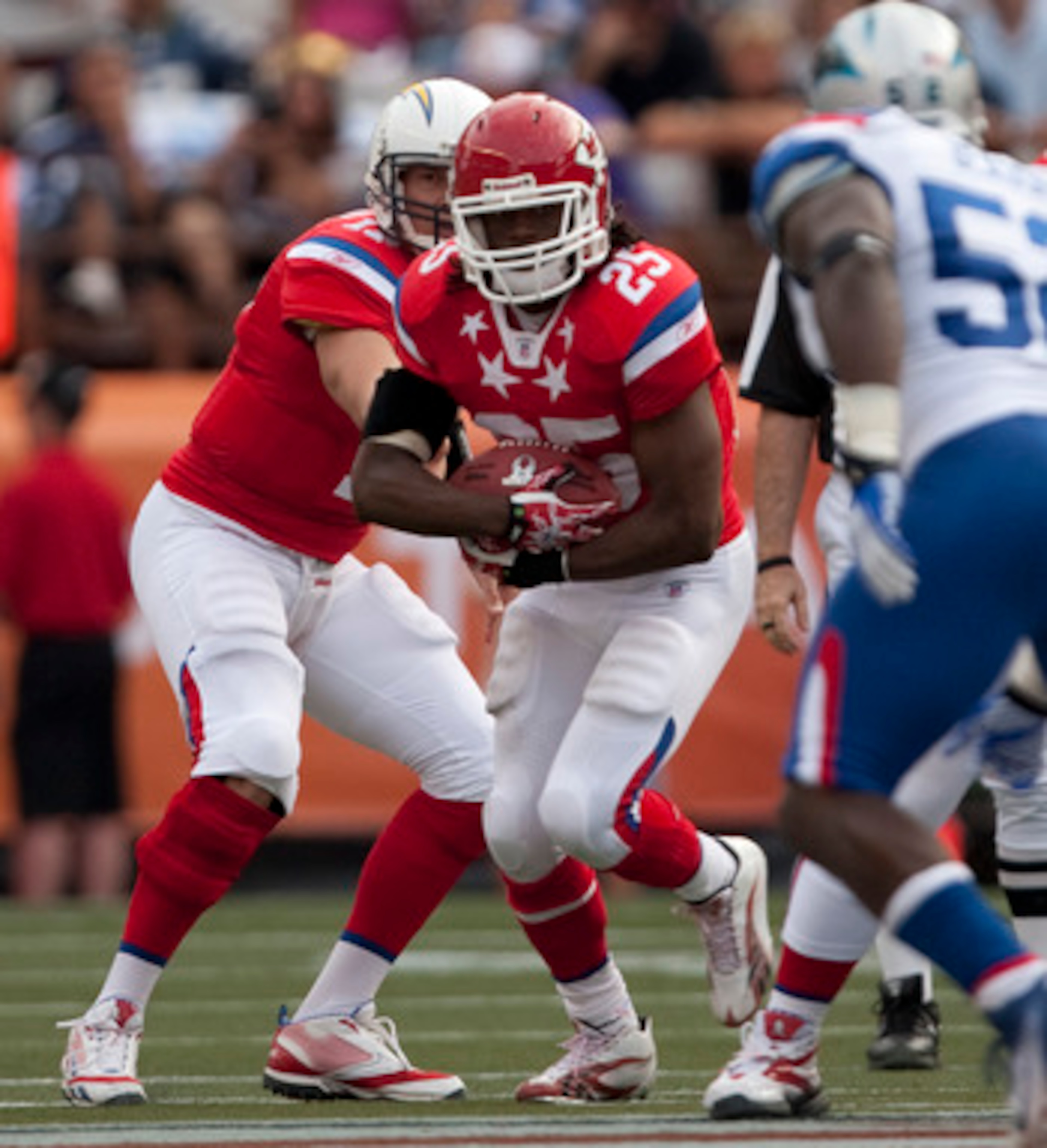 HONOLULU - JANUARY 30:  Jamaal Charles, #25 of the Kansas City Chiefs, is handed the ball by Philip Rivers, #17 of the San Diego Chargers, during the 2011 NFL Pro Bowl at Aloha Stadium on January 30, 2011 in Honolulu, Hawaii.  (Photo by Kent Nishimura/Get