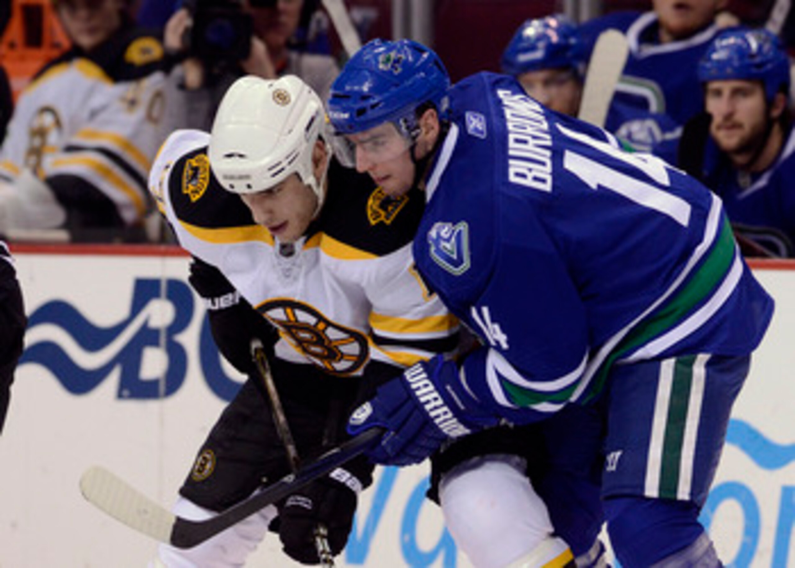 VANCOUVER, CANADA - FEBRUARY 26: Alexandre Burrows #14 of the Vancouver Canucks gets in close to Milan Lucic #17 of the Boston Bruins on a face-off during the third period in NHL action on February 26, 2011 at Rogers Arena in Vancouver, British Columbia, 