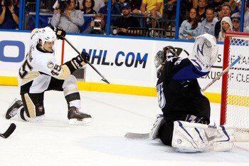 TAMPA, FL - APRIL 18: Arron Asham #45 of the Pittsburgh Penguins shoots and scores against Goaltender Dwayne Roloson #35 of the Tampa Bay Lightning in Game Three of the Eastern Conference Quarterfinals during the 2011 NHL Stanley Cup Playoffs at the St. P