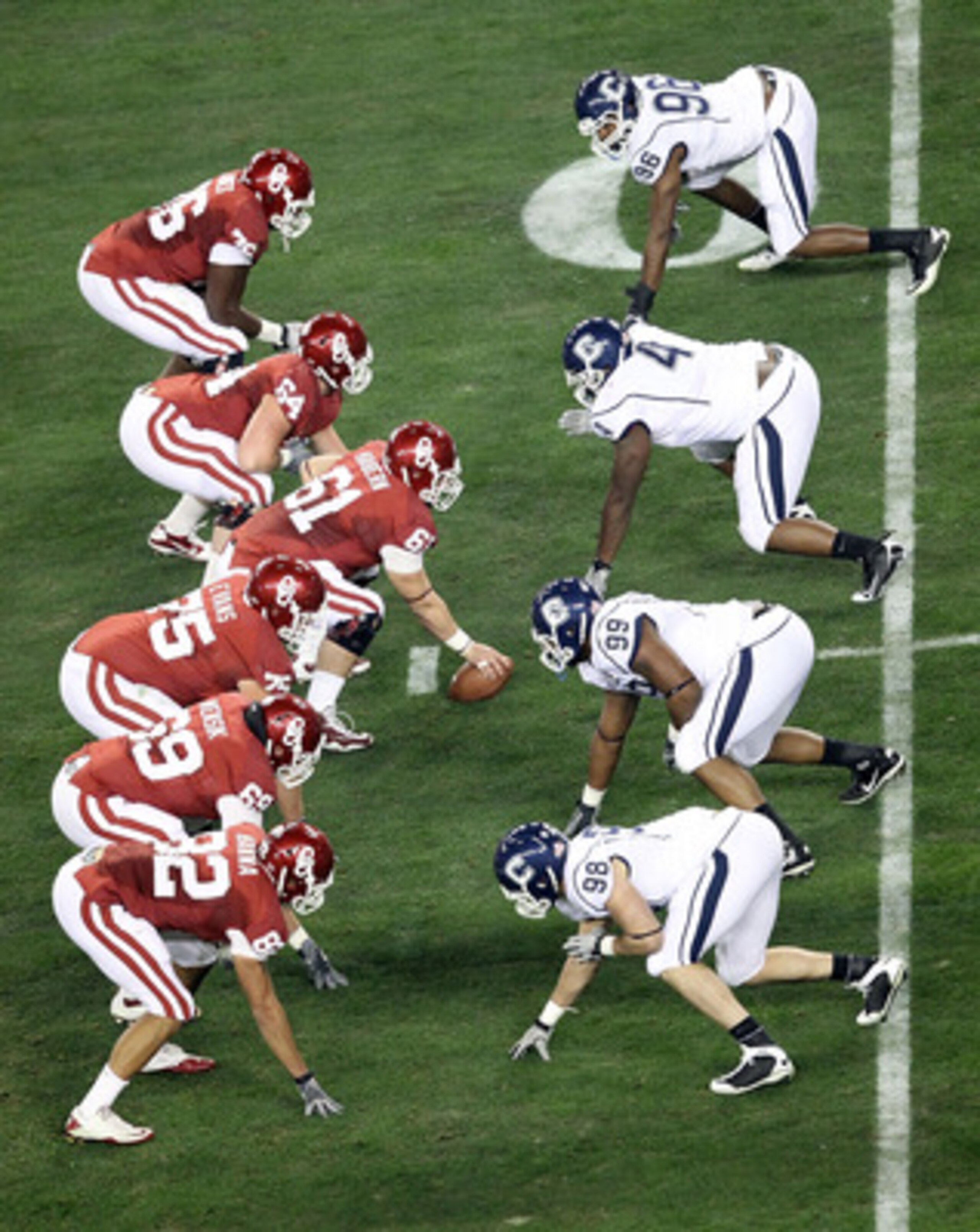GLENDALE, AZ - JANUARY 01:  The Oklahoma Sooners offensive line goes up against the Connecticut Huskies defensive line in the first quarter during the Tostitos Fiesta Bowl at the Universtity of Phoenix Stadium on January 1, 2011 in Glendale, Arizona.  (Ph