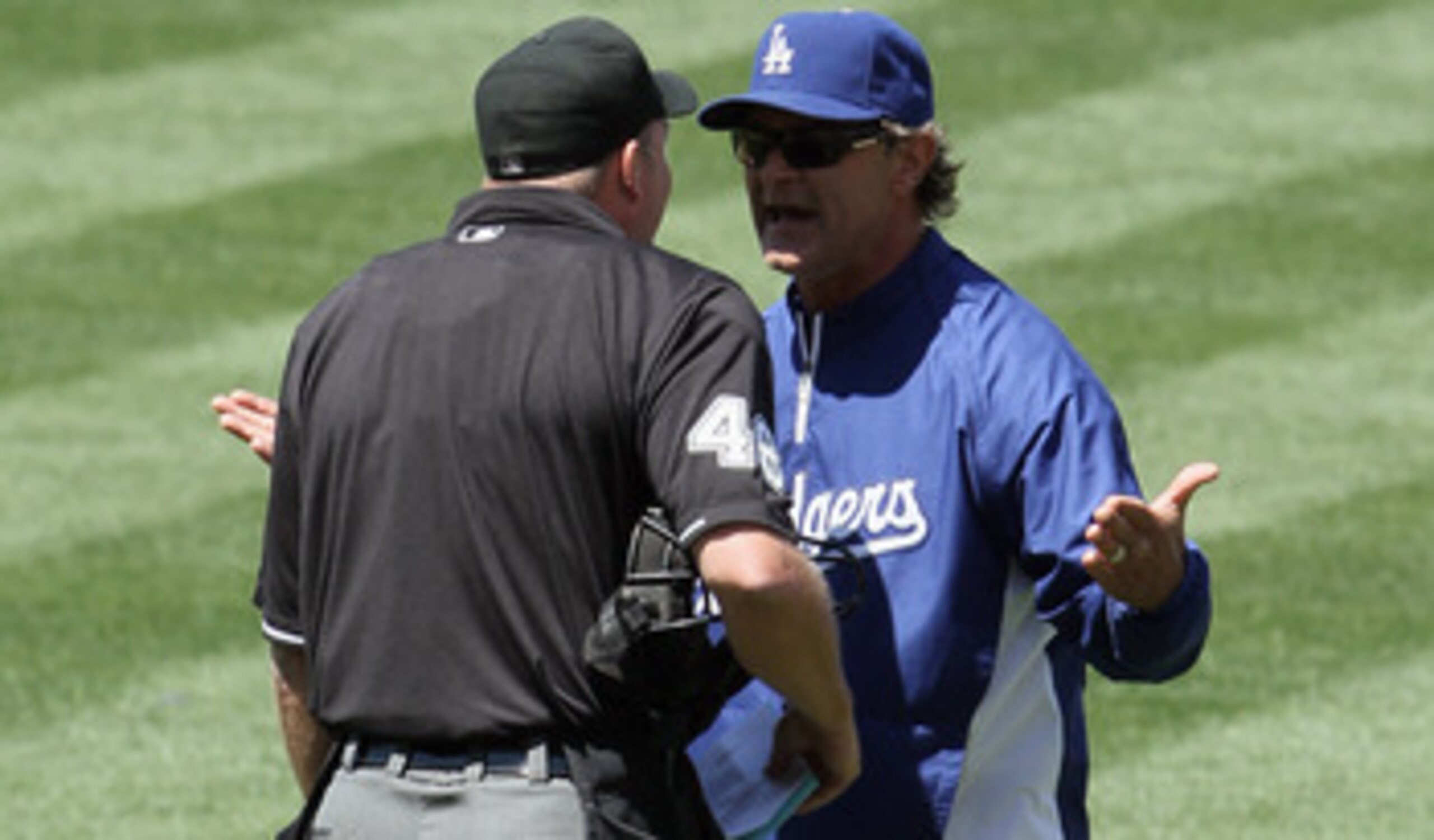 LOS ANGELES, CA - MAY 29:  Los Angeles Dodgers manager Don Mattingly (R) argues with home plate umpire Ron Kulpa in the top of the fifth inning against the Florida Marlins at Dodger Stadium on May 29, 2011 in Los Angeles, California. The Dodgers defeated