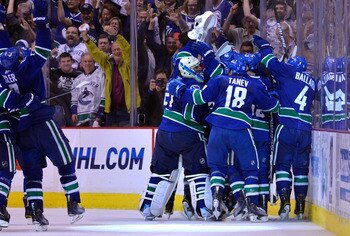 VANCOUVER, BC - MAY 24:  Ryan Kesler #17, goaltender Roberto Luongo #1, Chris Tanev #18 and Keith Ballard #4 of the Vancouver Canucks and their teammates celebrate after they defeated the San Jose Sharks 3-2 in double-overtime in Game Five to win the West