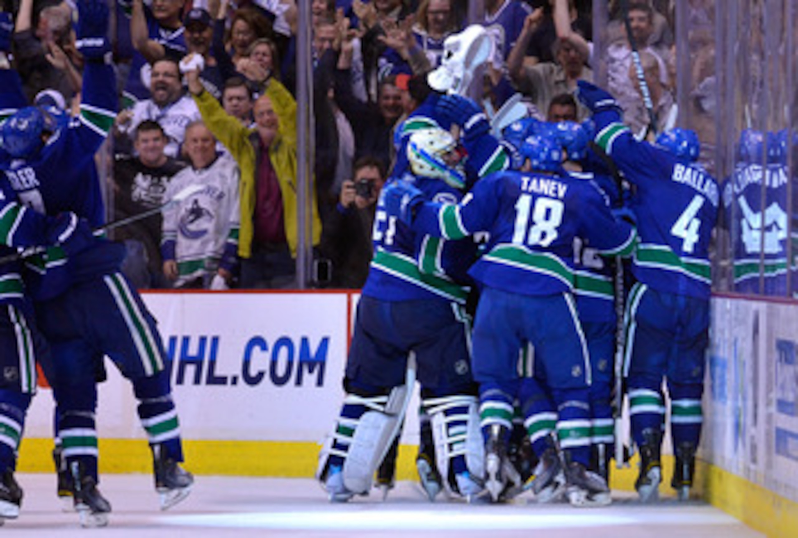 VANCOUVER, BC - MAY 24:  Ryan Kesler #17, goaltender Roberto Luongo #1, Chris Tanev #18 and Keith Ballard #4 of the Vancouver Canucks and their teammates celebrate after they defeated the San Jose Sharks 3-2 in double-overtime in Game Five to win the West