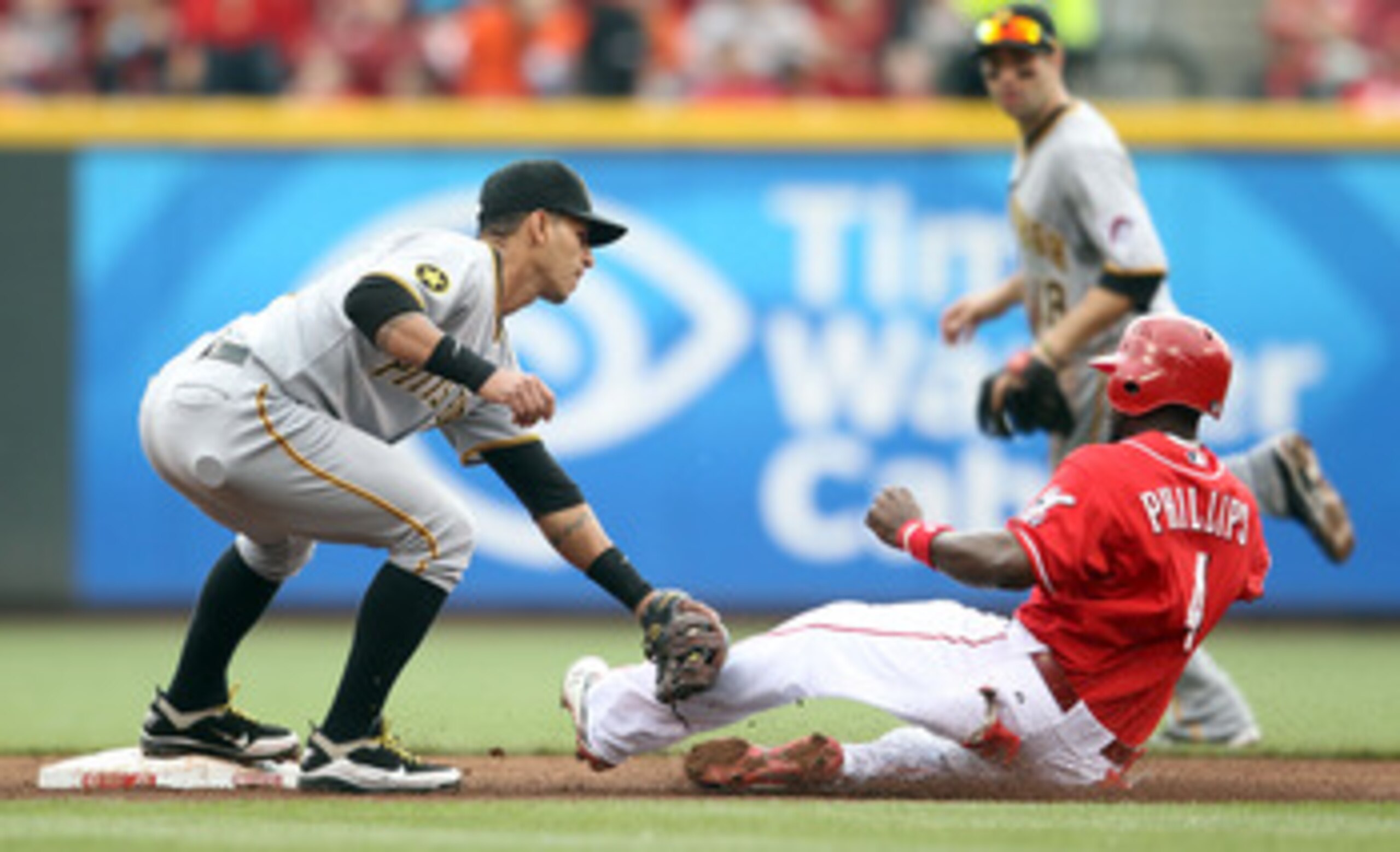 CINCINNATI, OH - MAY 19:  Ronny Cedeno #5 of the Pittsburgh Pirates tags out Brandon Phillips #4 of the Cincinnati Reds while he attempted to steal second base during the game at Great American Ball Park on May 19, 2011 in Cincinnati, Ohio.  (Photo by And