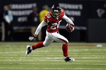 ATLANTA, GA - JANUARY 15:  Brent Grimes #20 of the Atlanta Falcons returns a fumble by Greg Jenning #85 of the Green Bay Packers in the first quarter during their 2011 NFC divisional playoff game at Georgia Dome on January 15, 2011 in Atlanta, Georgia.  (