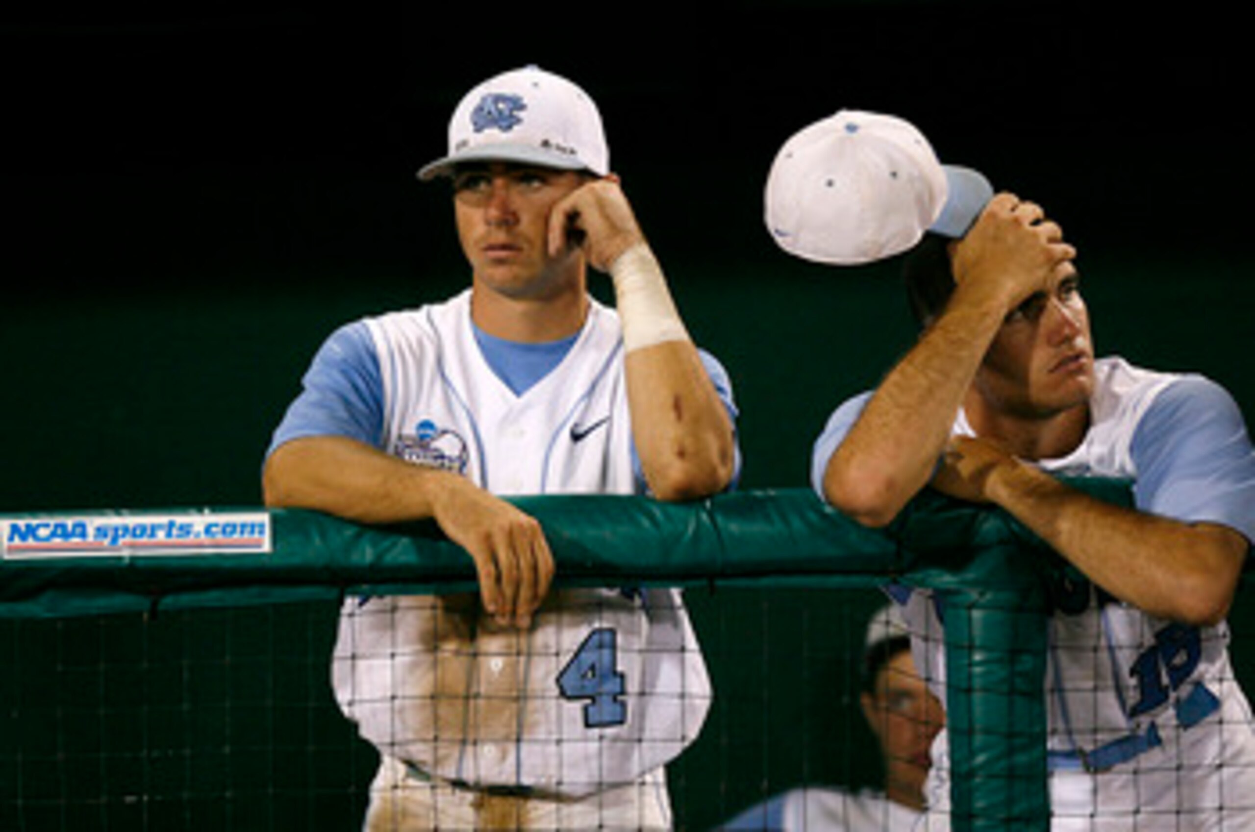 OMAHA, NE - JUNE 24:  Garrett Gore #4 and Rob Catapano #15 of the North Carolina Tar Heels stand dejected as the Oregon State Beavers celebrate their 9-3 win in Game 2 to claim their second straight NCAA College World Series Championship at Rosenblatt Sta