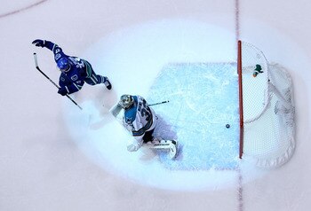 VANCOUVER, CANADA - MAY 24:  Goaltender Antti Niemi #31 of the San Jose Sharks looks on as Daniel Sedin #22 of the Vancouver Canucks celebrates after a deflection for a goal by Ryan Kesler #17 of the Vancouver Canucks (not in photo) sent the game into ove