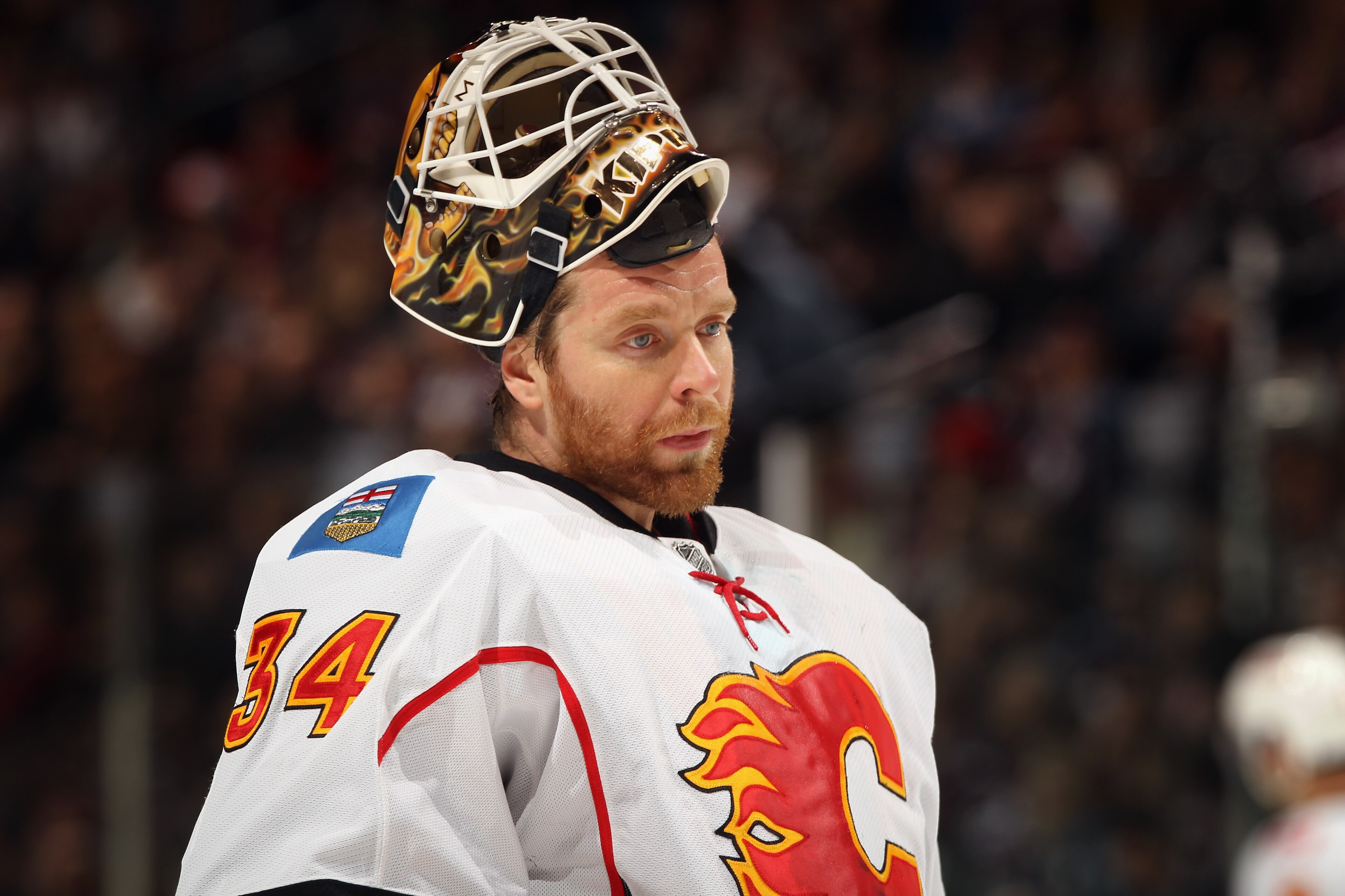 DENVER, CO - FEBRUARY 14: Goalie Mikka Kiprusoff #34 of the Calgary Flames looks on during a break in the action against the Colorado Avalanche at the Pepsi Center on February 14, 2011 in Denver, Colorado. The Flames defeated the Avalanche 9-1. (Photo b DENVER, CO - FEBRUARY 14: Goalie Mikka Kiprusoff #34 of the Calgary Flames looks on during a break in the action against the Colorado Avalanche at the Pepsi Center on February 14, 2011 in Denver, Colorado. The Flames defeated the Avalanche 9-1. (Photo b