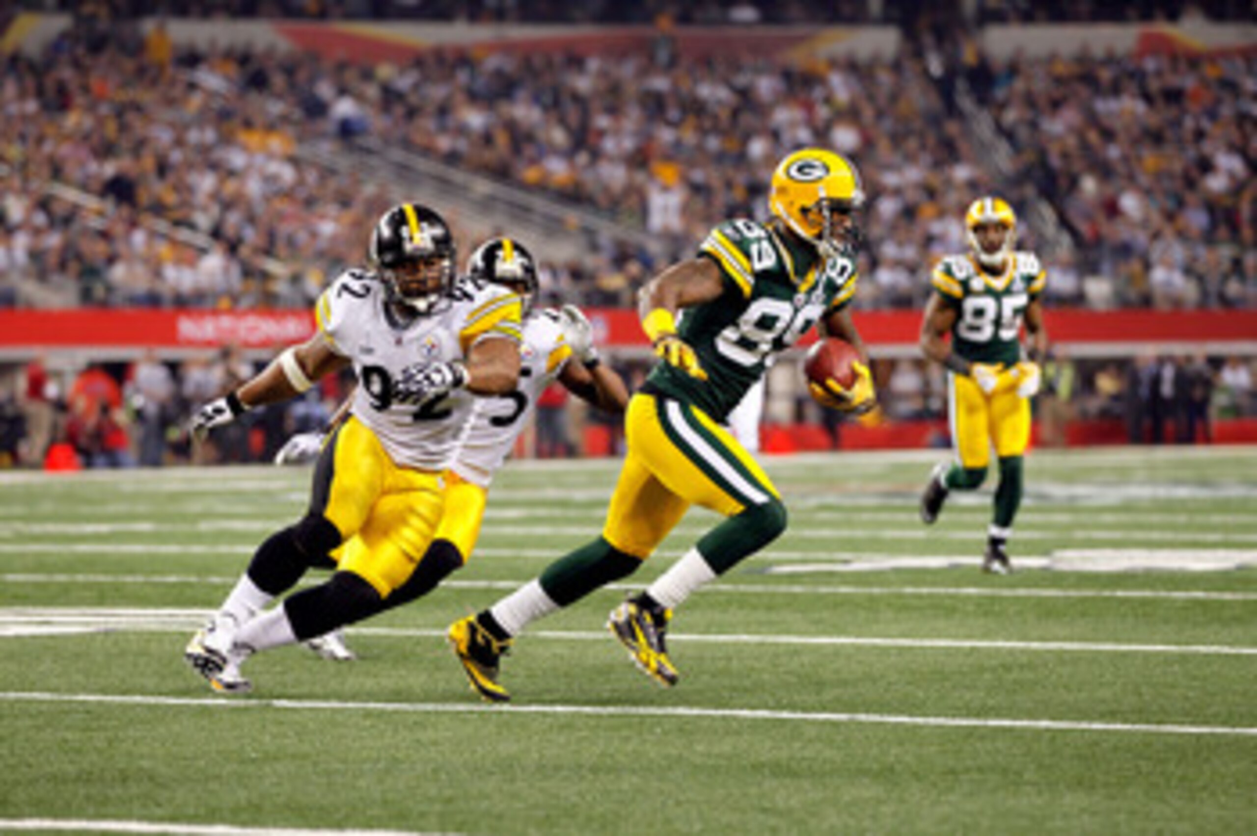ARLINGTON, TX - FEBRUARY 06:  James Jones #89 of the Green Bay Packers runs for yards after the catch against James Harrison #92 of the Pittsburgh Steelers during Super Bowl XLV at Cowboys Stadium on February 6, 2011 in Arlington, Texas. The Packers won 3
