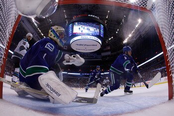 VANCOUVER, CANADA - MAY 24:  Kevin Bieksa #3 and goaltender Roberto Luongo #1 of the Vancouver Canucks defend their net in Game Five of the Western Conference Finals against the San Jose Sharks during the 2011 Stanley Cup Playoffs at Rogers Arena on May 2