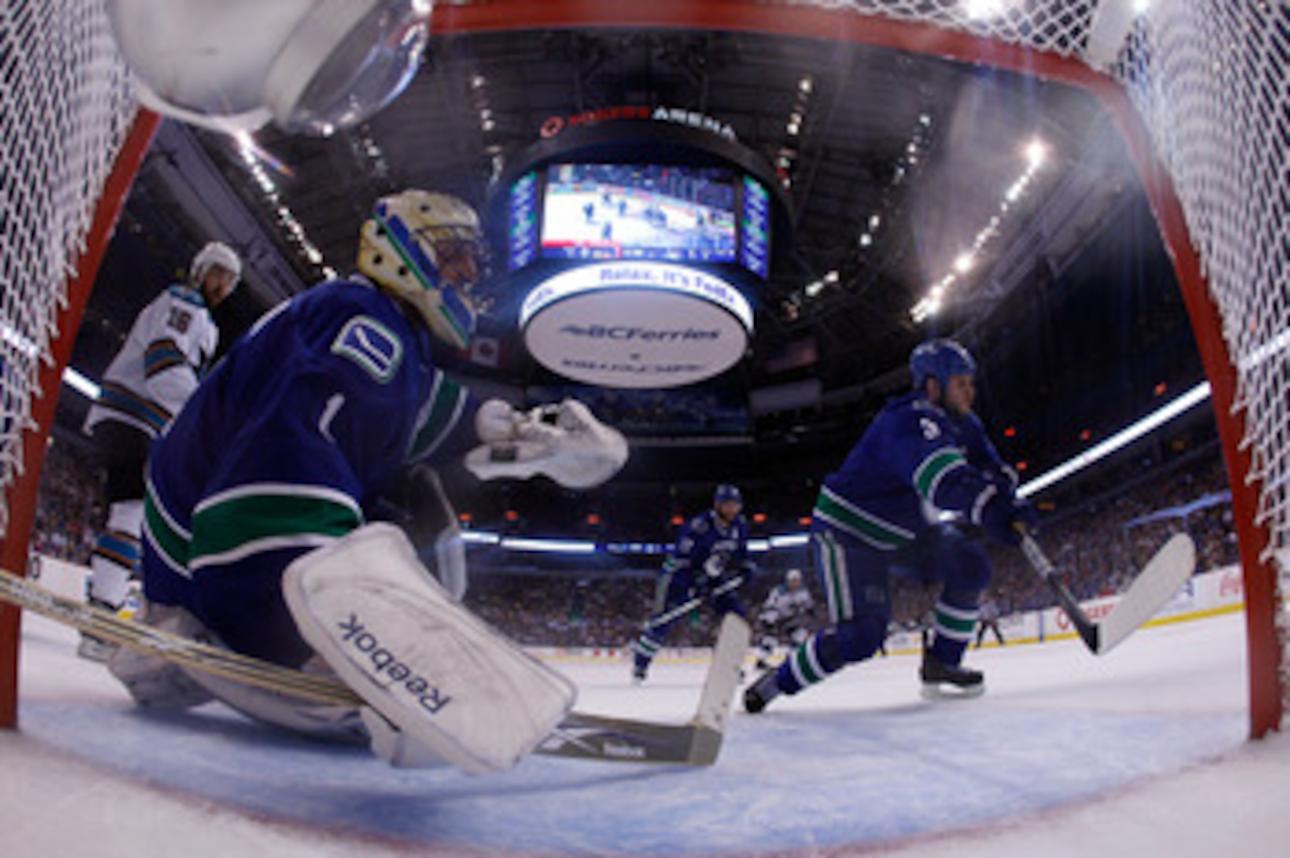 VANCOUVER, CANADA - MAY 24:  Kevin Bieksa #3 and goaltender Roberto Luongo #1 of the Vancouver Canucks defend their net in Game Five of the Western Conference Finals against the San Jose Sharks during the 2011 Stanley Cup Playoffs at Rogers Arena on May 2