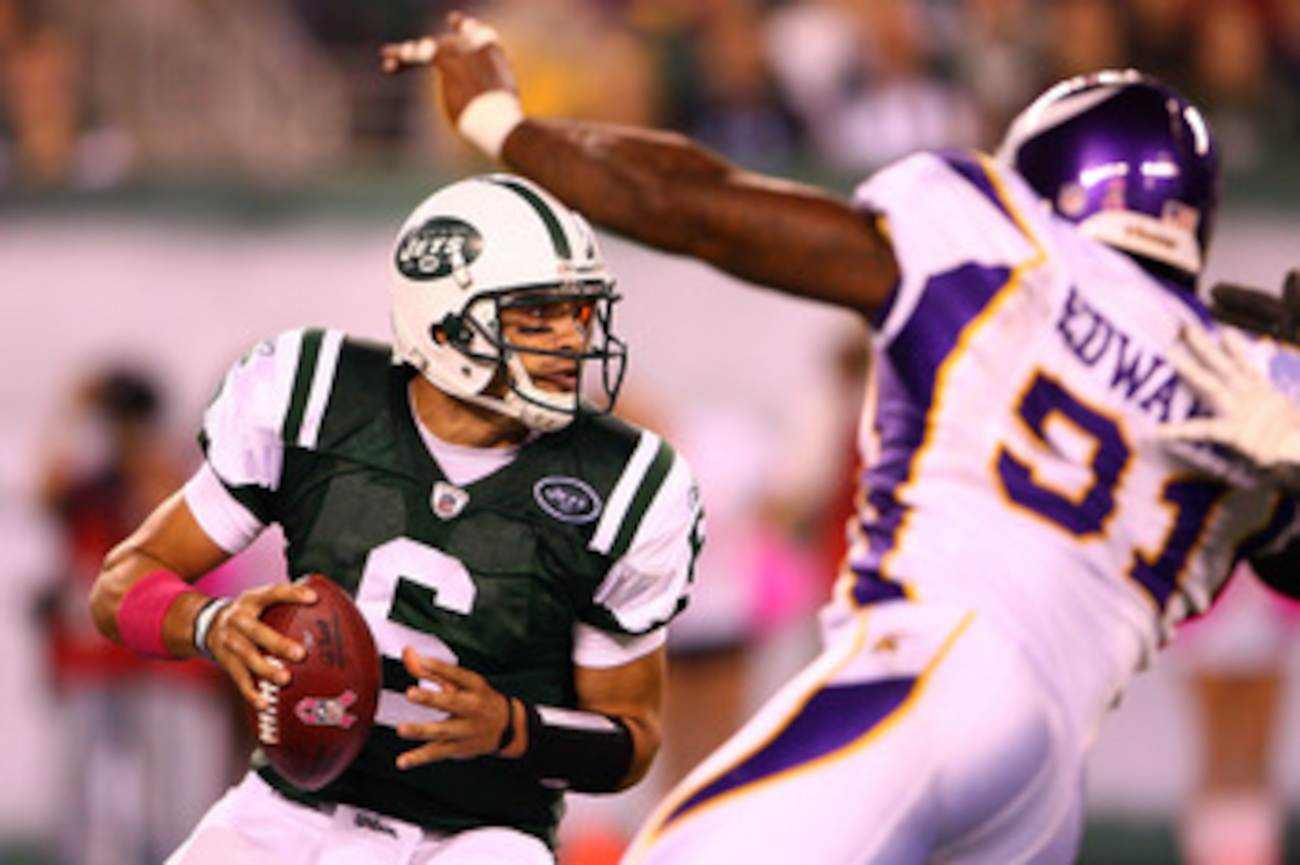 EAST RUTHERFORD, NJ - OCTOBER 11:  Quarterback Mark Sanchez #6 of the New York Jets looks to pass in the first half against Ray Edwards #91 of the Minnesota Vikings at New Meadowlands Stadium on October 11, 2010 in East Rutherford, New Jersey.  (Photo by 