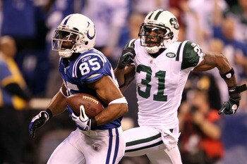 INDIANAPOLIS, IN - JANUARY 08:  Pierre Garcon #85 of the Indianapolis Colts scores on a 57-yard touchdown reception in the seocnd quarter against Antonio Cromartie #31 of the New York Jets during their 2011 AFC wild card playoff game at Lucas Oil Stadium 