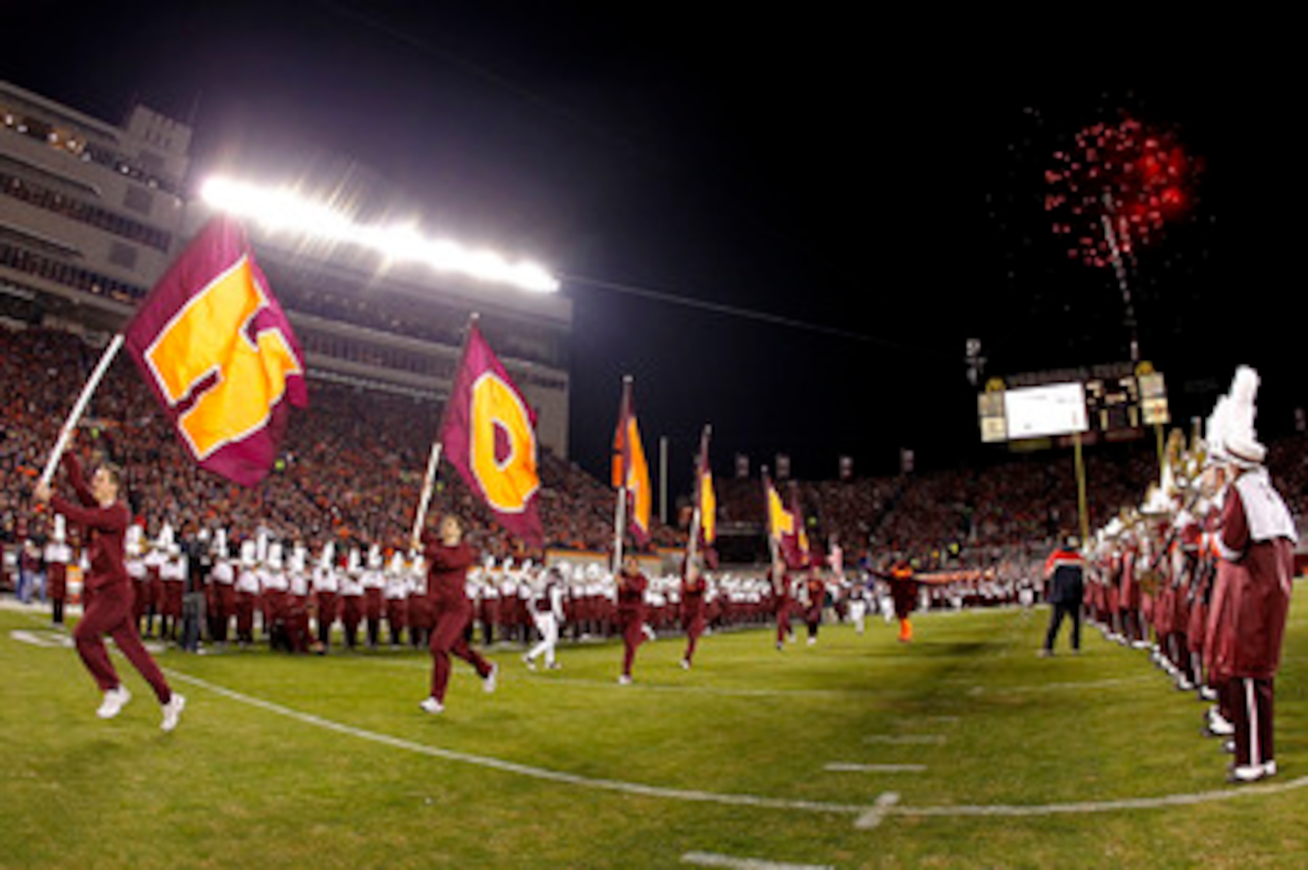 BLACKSBURG, VA - NOVEMBER 04: Cheerleaders from the Virginia Tech Hokies lead the players onto the field prior to the Hokies game against the Georgia Tech Yellow Jackets at Lane Stadium on November 4, 2010 in Blacksburg, Virginia.  (Photo by Geoff Burke/G