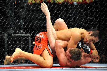 LAS VEGAS - JULY 11:  (L-R) Dong Hyun Kim battles T.J. Grant during their welterweight bout during UFC 100 on July 11, 2009 in Las Vegas, Nevada. Kim defeated Grant by unanimous decision.  (Photo by Jon Kopaloff/Getty Images)