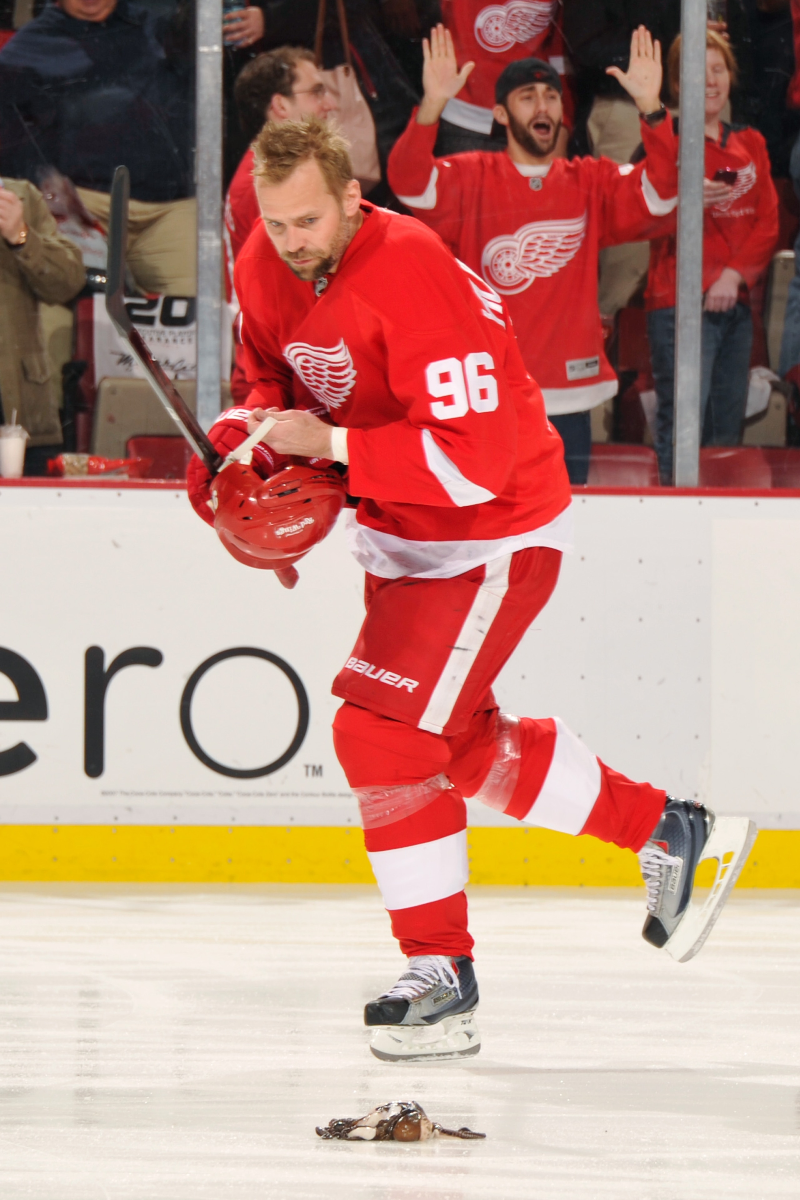 DETROIT - MAY 4:  Tomas Holmstrom #96 of the Detroit Red Wings looks at an octopus thrown on the ice before Game Three of the Western Conference Semifinals against the San Jose Sharks during the 2011 NHL Stanley Cup Playoffs on May 4, 2011 at Joe Louis Ar