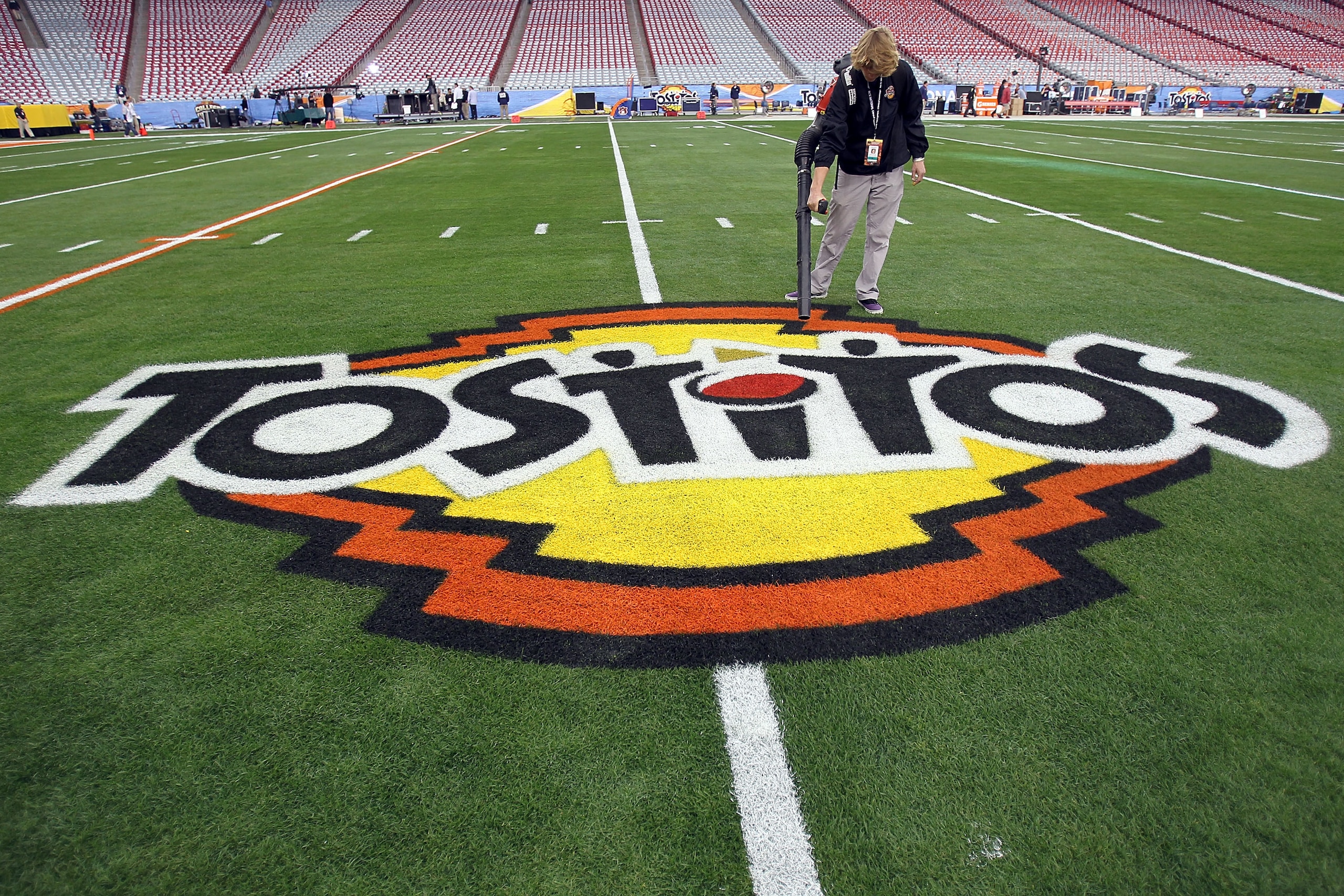 GLENDALE, AZ - JANUARY 10:  A grounds crew member dries the logo on the field at the Tostitos BCS National Championship Game before the Oregon Ducks and the Auburn Tigers take the field at University of Phoenix Stadium on January 10, 2011 in Glendale, Ari